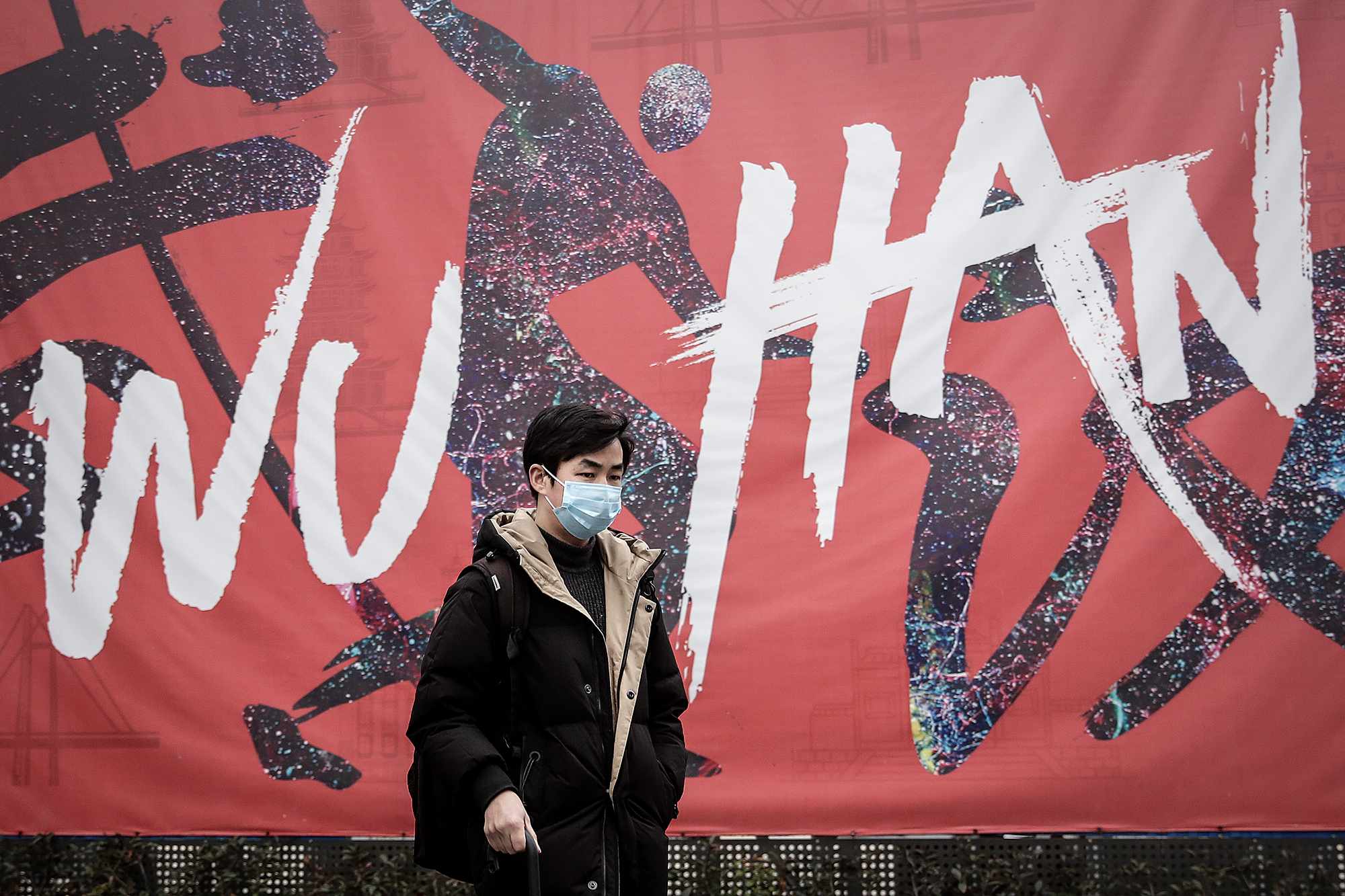 A man wears a mask while walking in the street on Wednesday in Wuhan