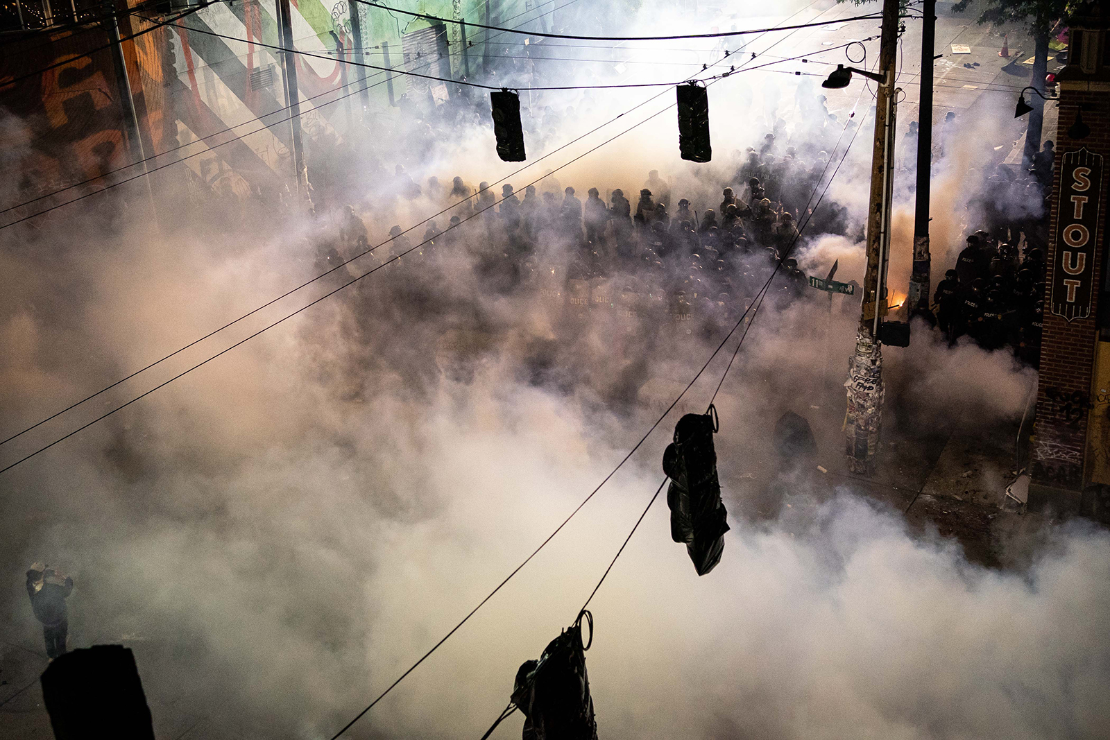 Smoke fills the air as demonstrators clash with police near the Seattle Police Departments East Precinct shortly after midnight on Monday, June 8, in Seattle.