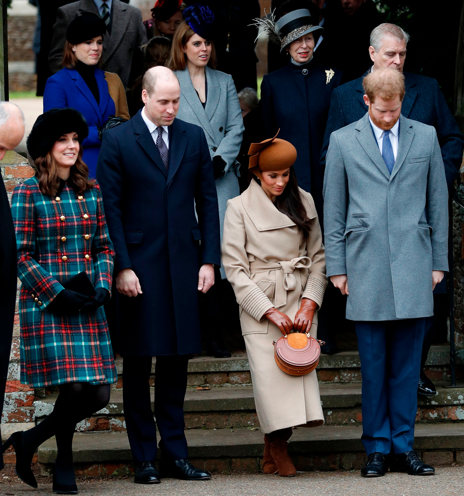 Meghan Markle curtsies as she sees off Britain's Queen Elizabeth II leaving after the Royal Family's traditional Christmas Day church service at St Mary Magdalene Church in Sandringham, Norfolk, eastern England, on December 25, 2017.