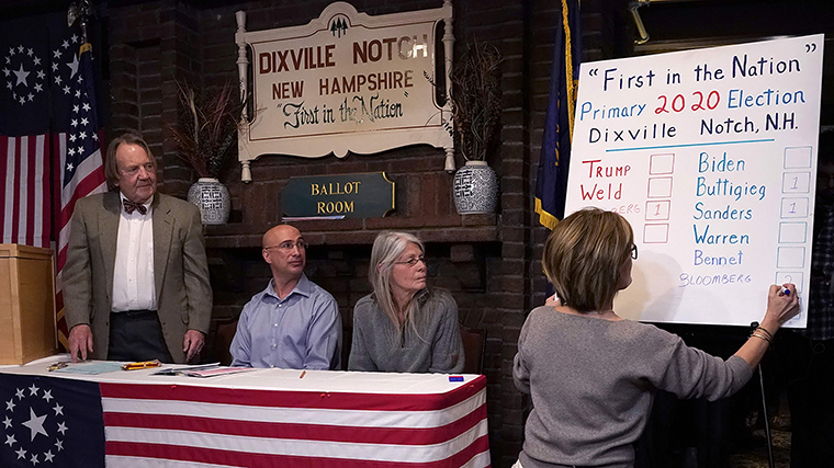 Results are written on a board just after midnight voting at the Hale House at the legendary Balsams Resort in the New Hampshire hamlet of Dixville Notch on Tuesday, February 11, where midnight voting took place on the day of the state's first-in-the-nation primary. 