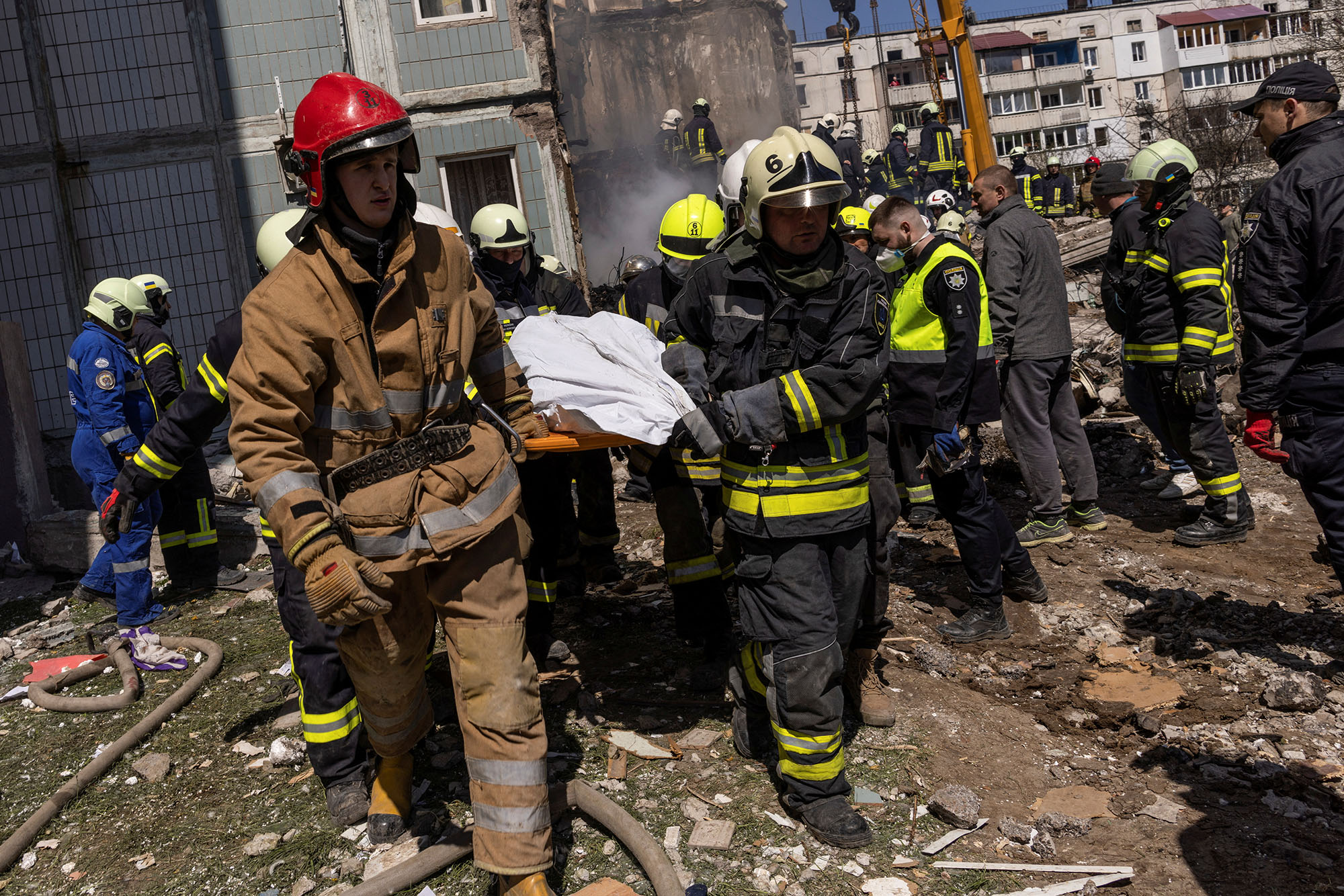 Rescuers carry a covered body as they work at the site of a heavily damaged residential building in the town of Uman, Cherkasy region, Ukraine, on April 28.