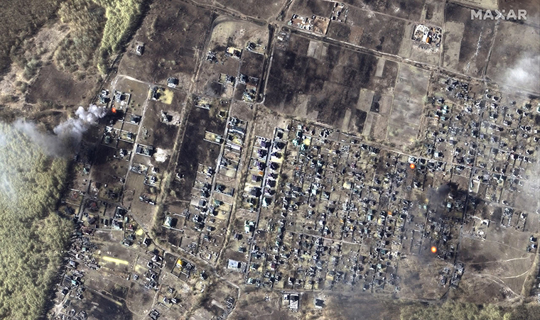 A color infrared satellite image shows burning homes in Moschun, Ukraine. 