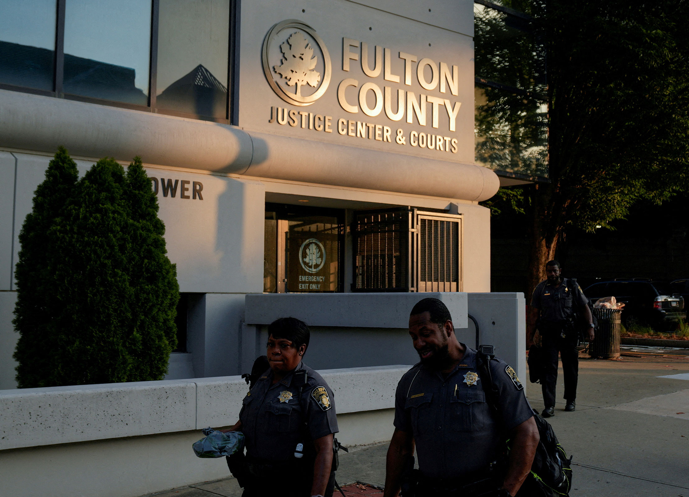 Police officers walk past the Lewis R. Slaton Courthouse after a grand jury brought back indictments against former President Donald Trump and 18 of his allies in their attempt to overturn the state's 2020 election results, in Atlanta, Georgia, on August 15.