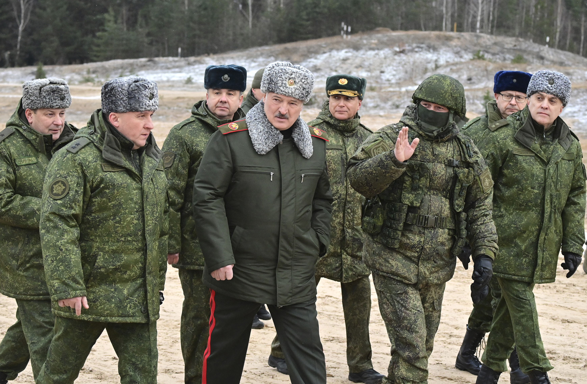 Belarusian President Alexander Lukashenko, center, walks during his meeting with military top officials at the Obuz-Lesnovsky training ground, Belarus, on January 6.