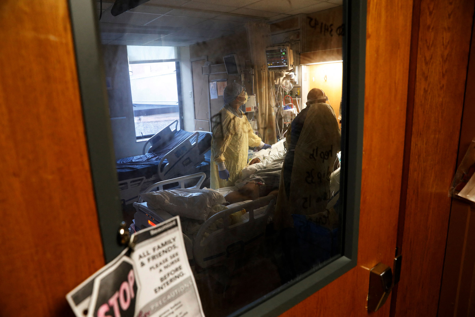 US Army Critical Care Nurse, Captain Edward Rauch Jr., left, tends to a Covid-19 patient on a ventilator at Beaumont Hospital in Dearborn, Michigan, on December, 17, 2021. 