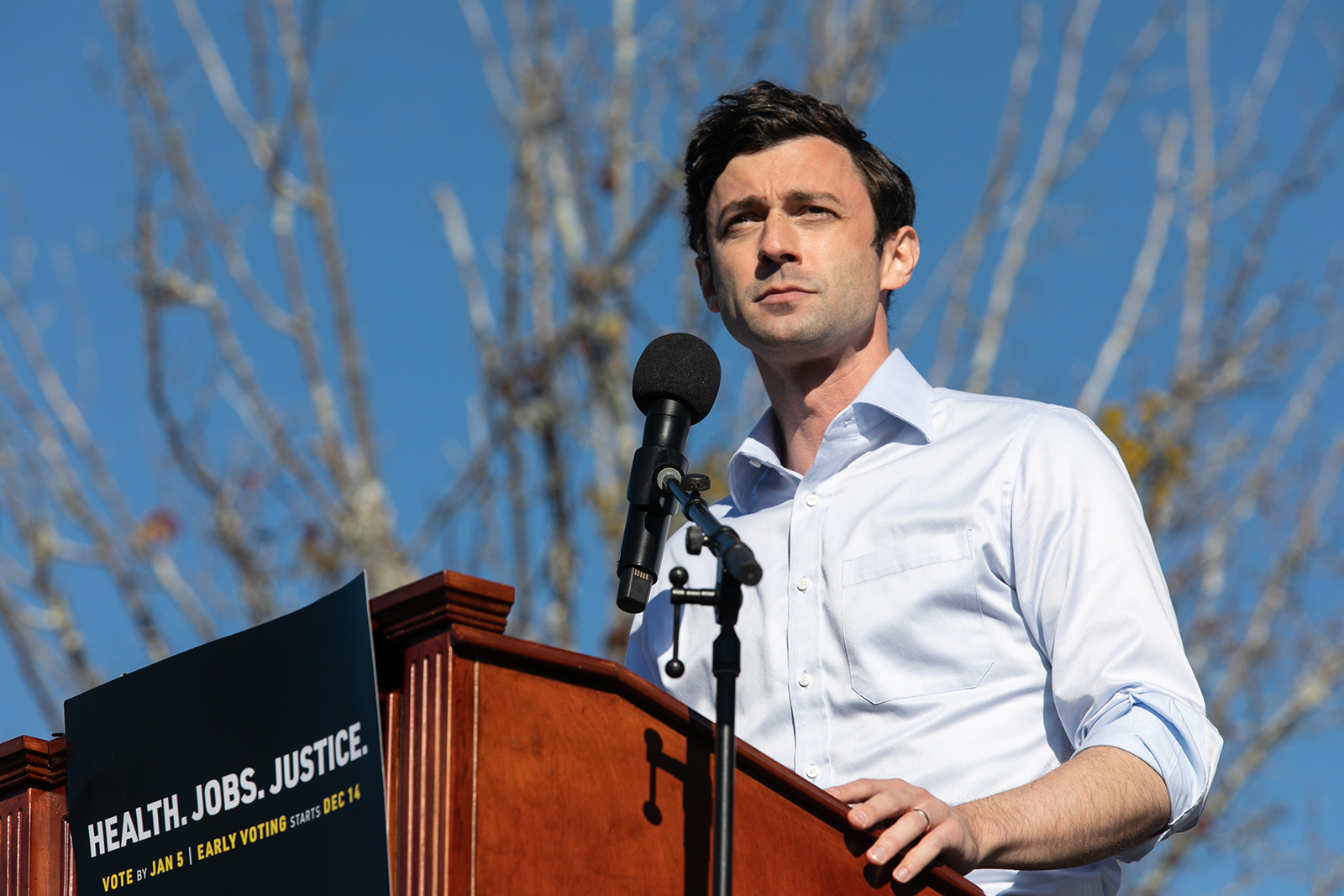 Senate candidate Jon Ossoff speaks to the crowd during an outdoor drive-in rally on December 5, in Conyers, Georgia.