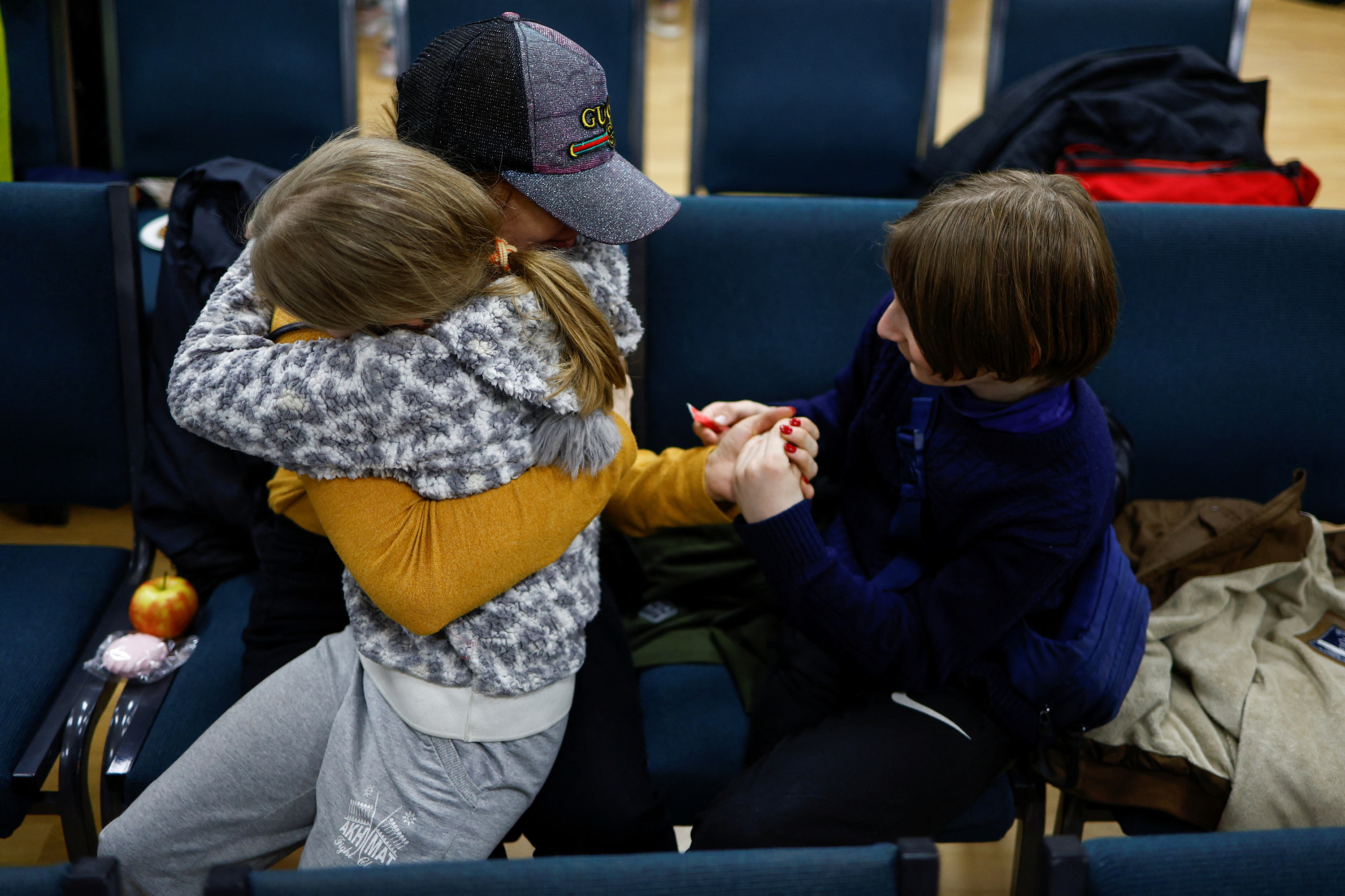 Anastasiia holds her daughter Valeriia and son Maksym after being reunited in Kyiv on April 8.