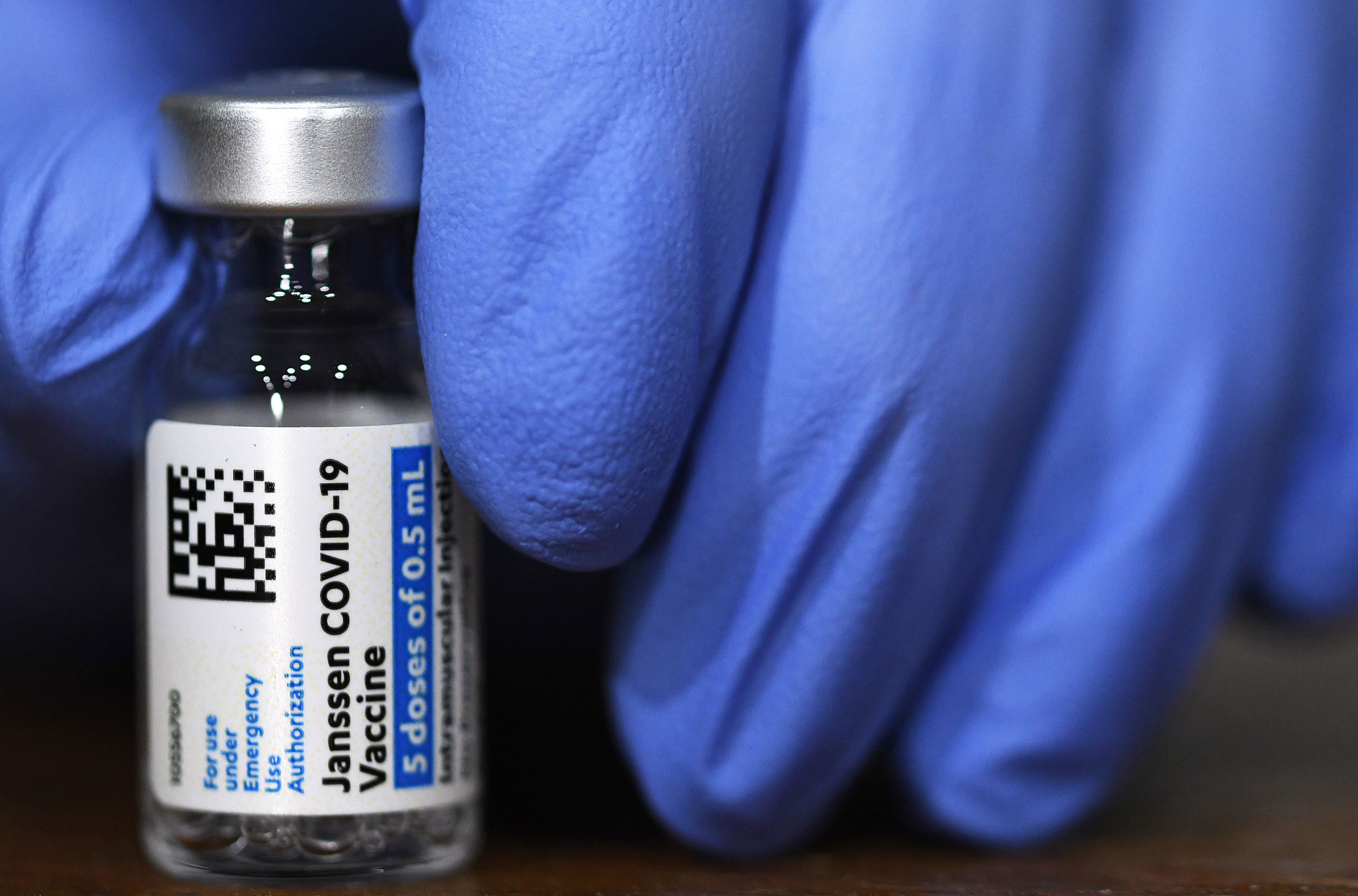 An Army nurse holds a vial of the Johnson & Johnson Covid-19 vaccine in Orlando.
