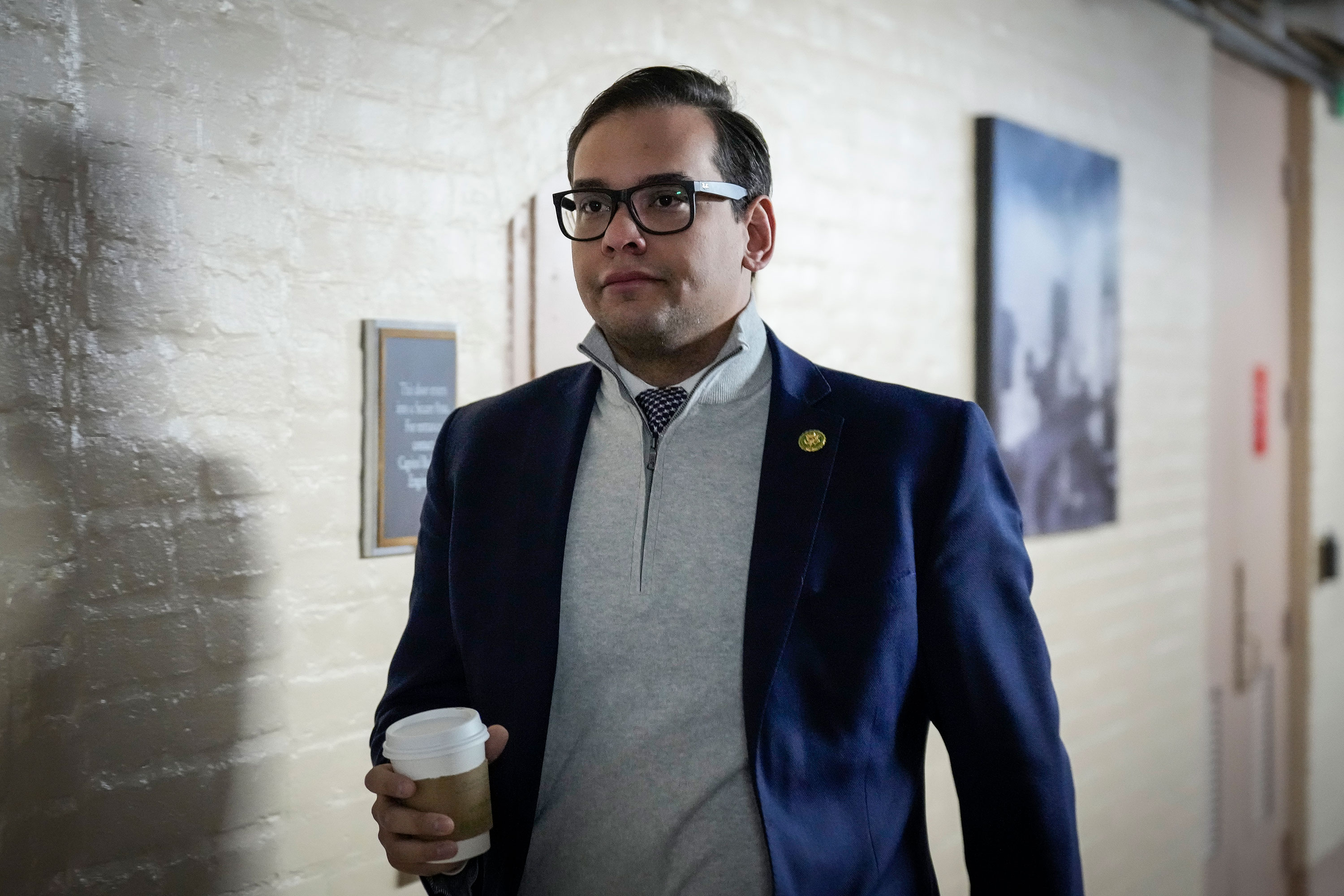 Rep. George Santos walks to a closed-door GOP caucus meeting at the Capitol on January 10.