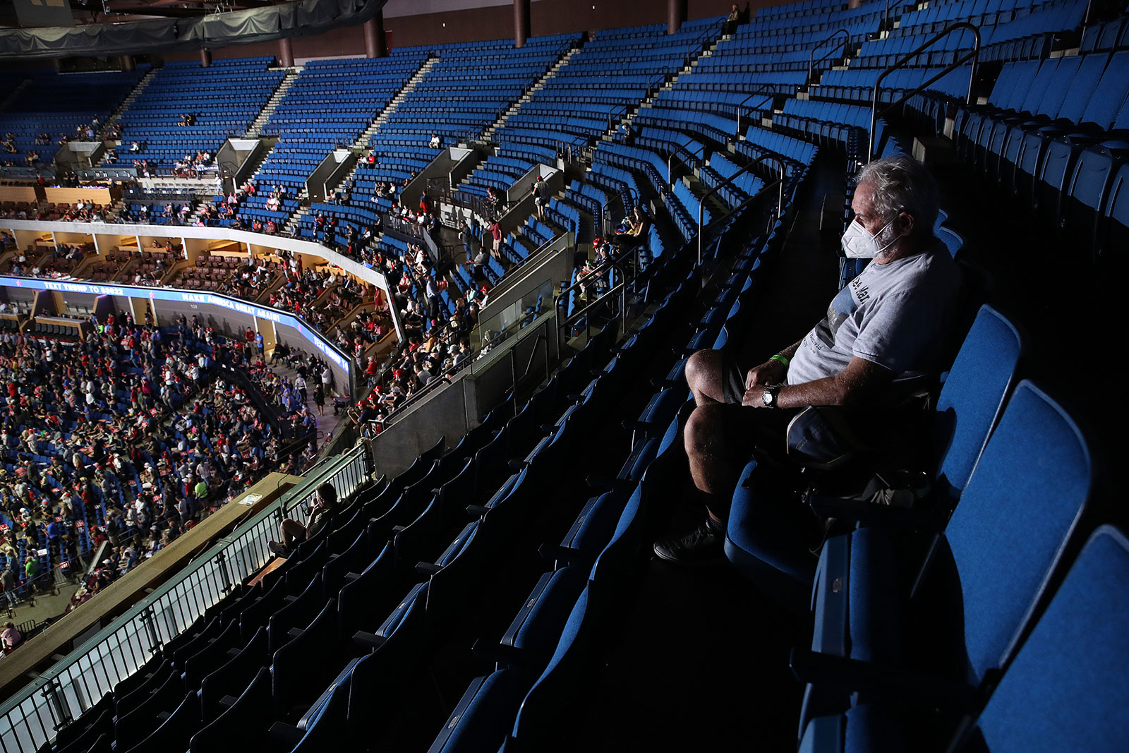 An attendee sits in the upper section of the Bank of Oklahoma Center prior to Trump's campaign rally on Saturday.