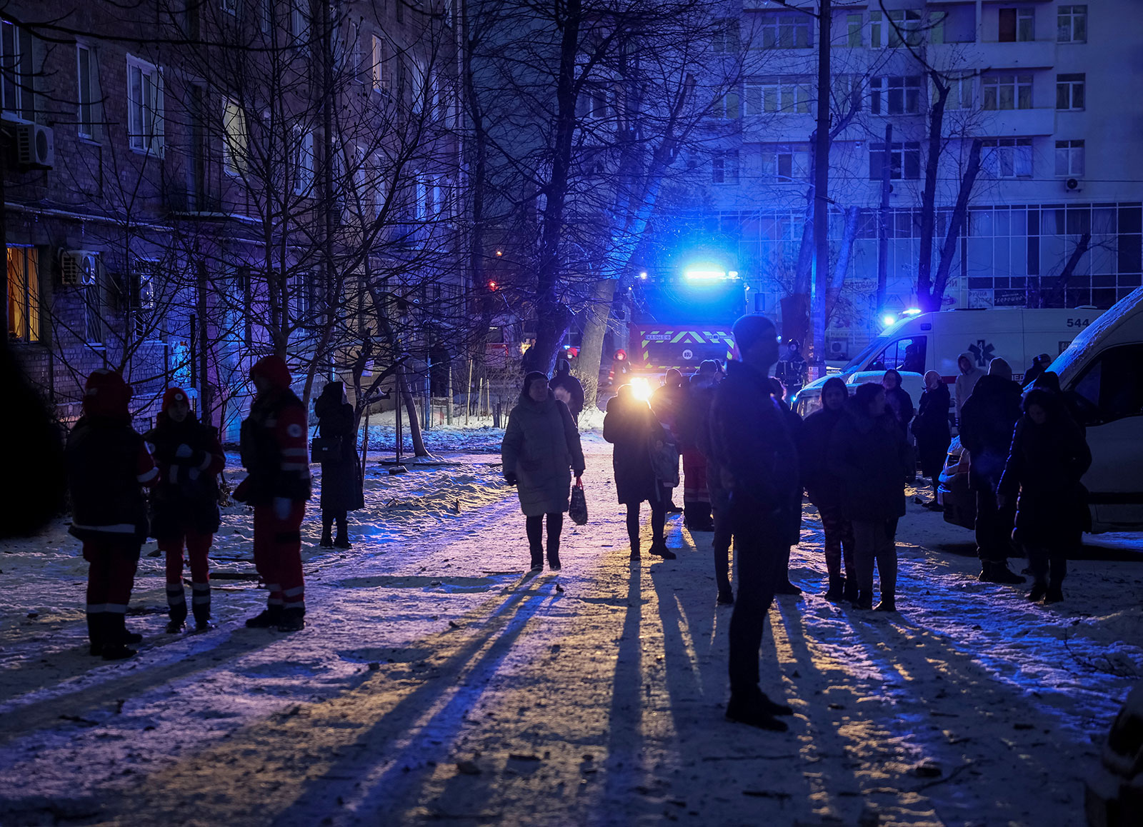 Local residents gather near a building destroyed by a Russian drone attack in Kyiv on December 14. 
