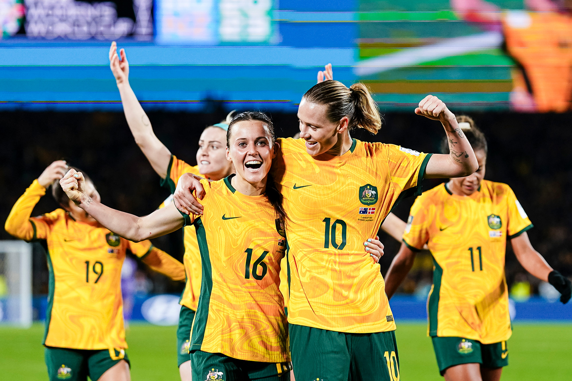 Hayley Raso, left, and Emily Van Egmond of Australia celebrate with their teammates after winning the match against Denmark. 