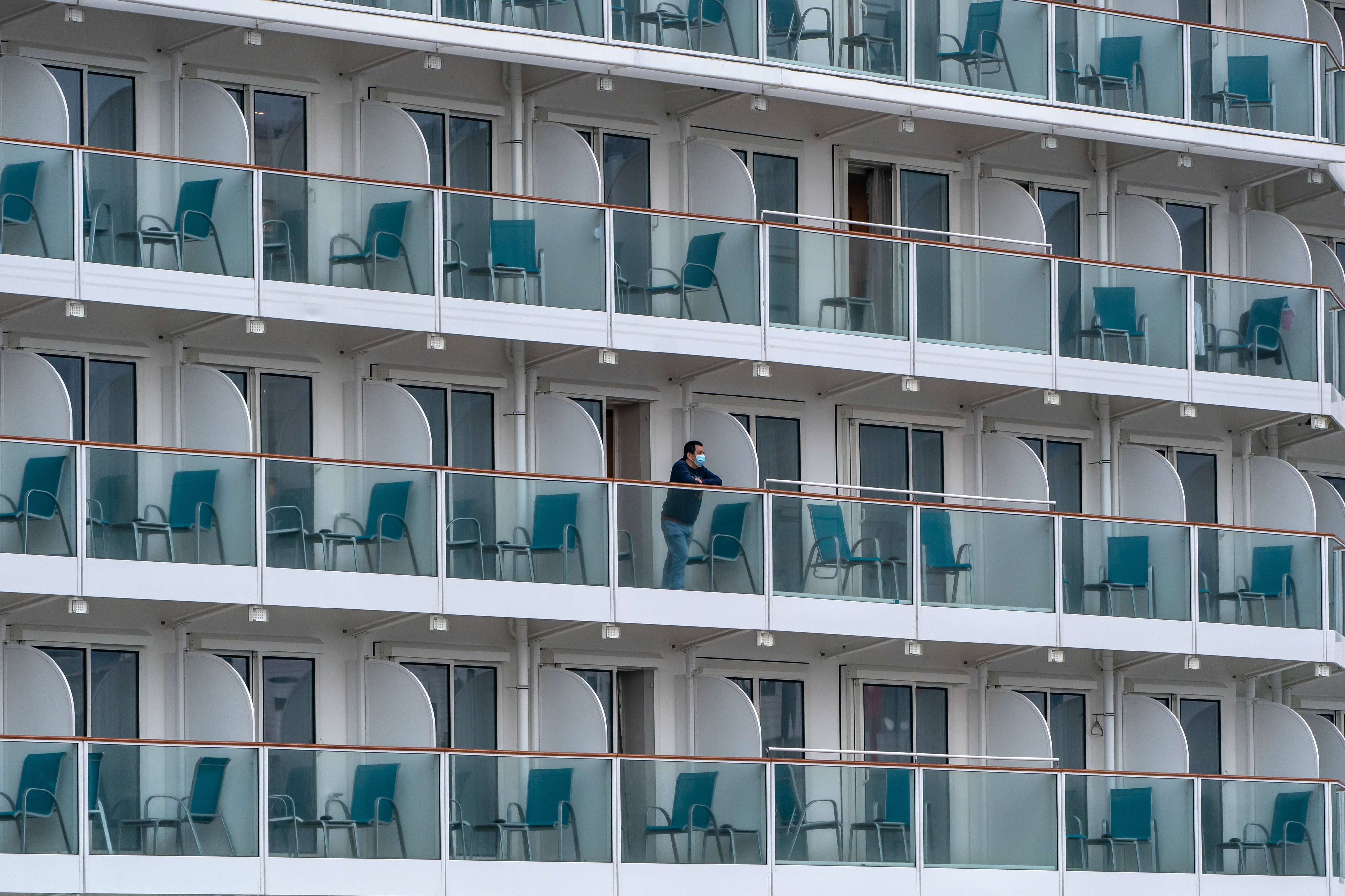 A passenger aboard The World Dream cruise ship as it sits moored in Hong Kong on February 5, 2020.