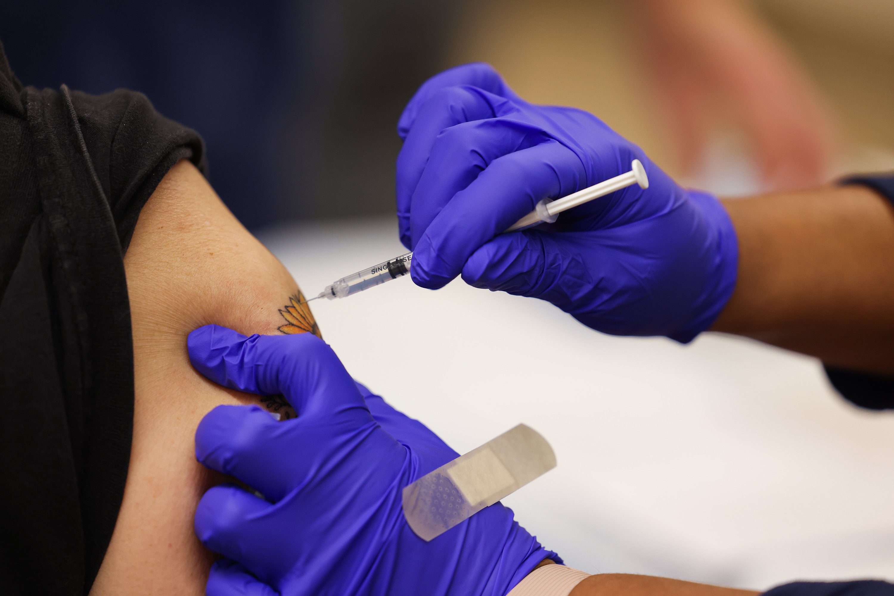A booster shot of the Pfizer COVID-19 vaccine is being injected into the arm of a person in Freeport, New York on November 30, 2021.