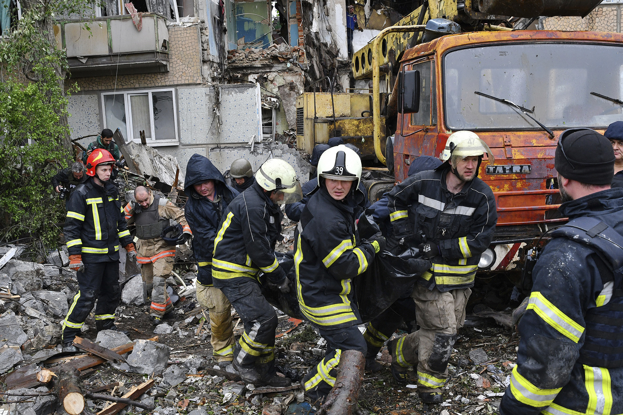 Rescuers remove the body of a civilian at the site of an apartment building destroyed by Russian shelling in Bakhmut, Donetsk region, Ukraine, on May 18.
