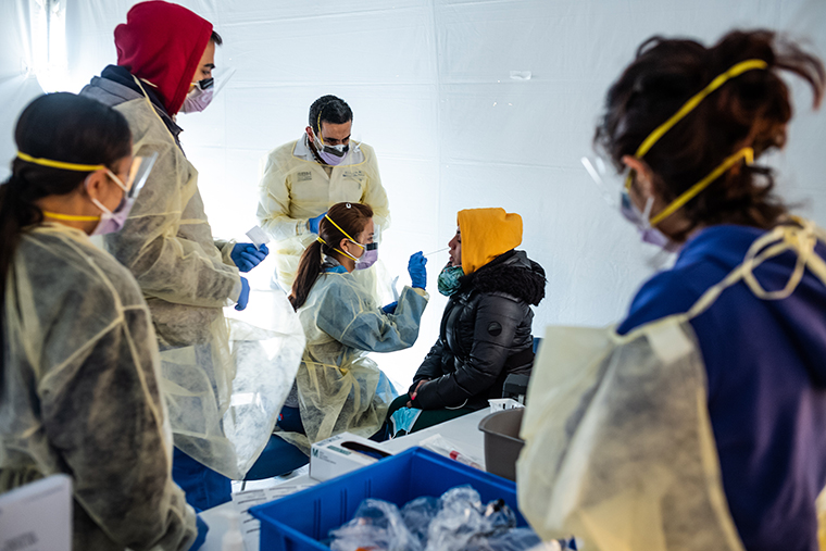 Doctors test hospital staff with flu-like symptoms for coronavirus in tents set up to triage possibly infected patients outside before they enter the main Emergency department area at St. Barnabas hospital in the Bronx on Tuesday, March 24, in New York City.
