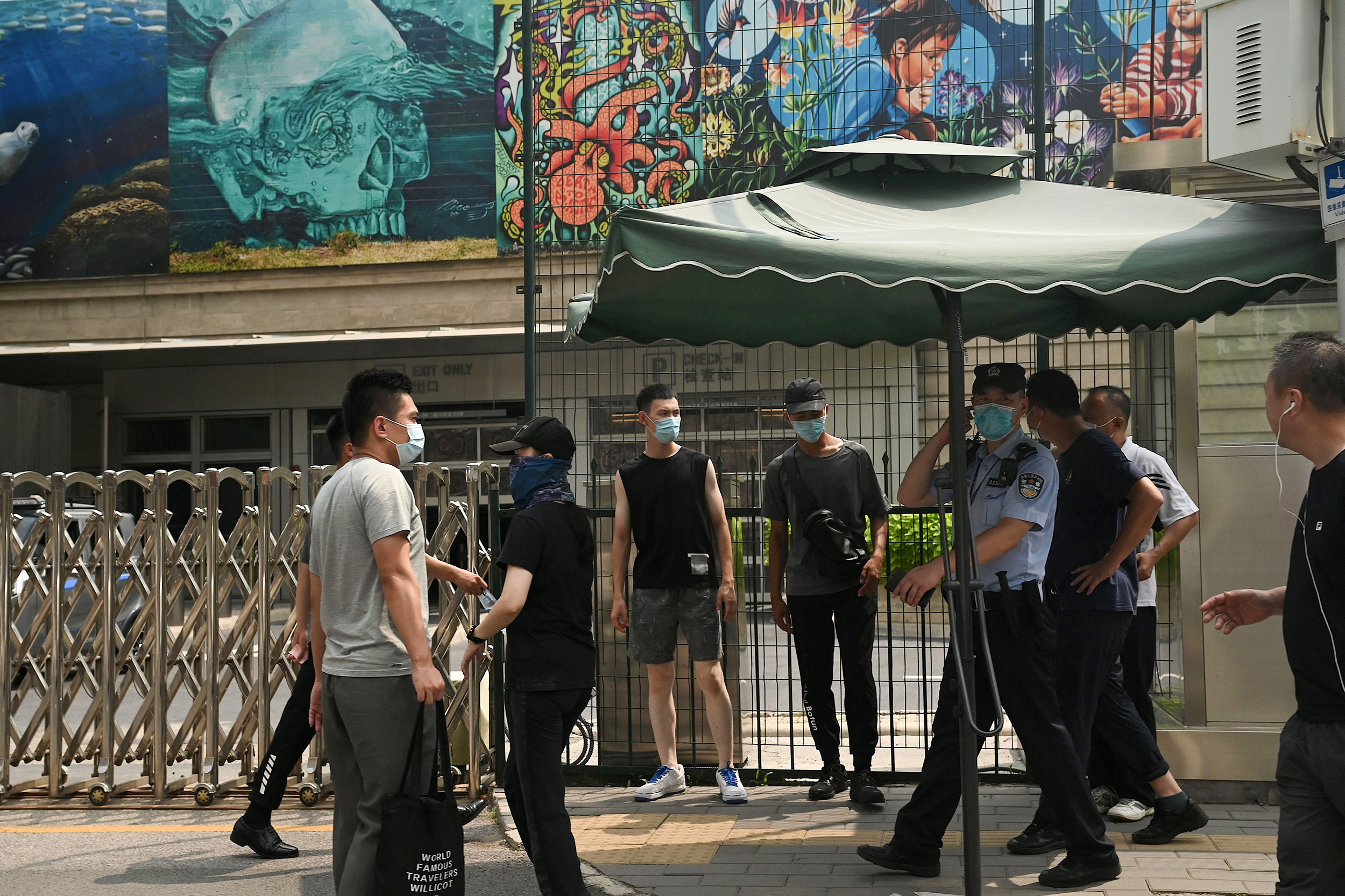 Police officers and plain clothes security personnel are seen in front of the US Embassy in Beijing, China, on August 3.