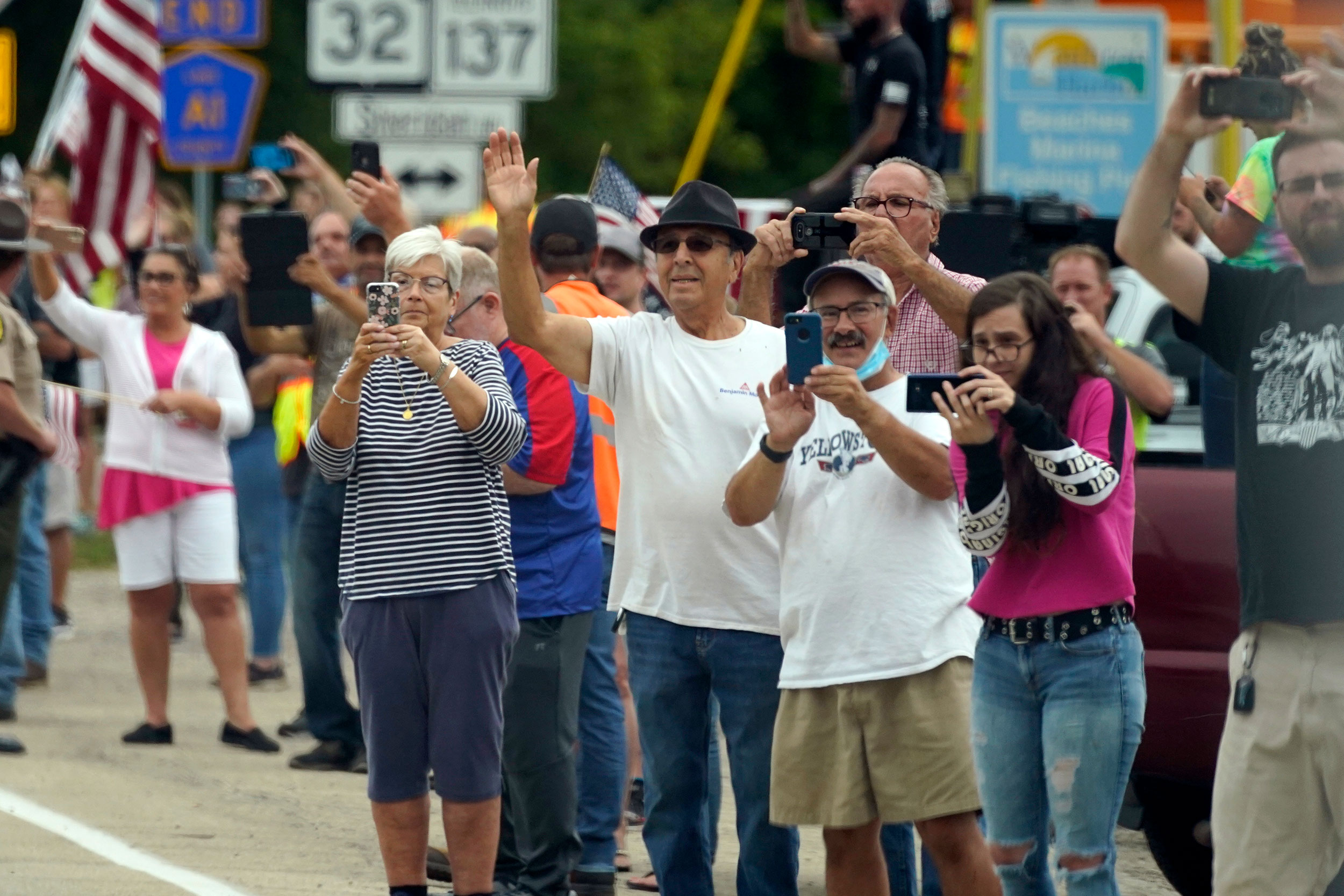 People wave at President Trump's motorcade in Kenosha on September 1.