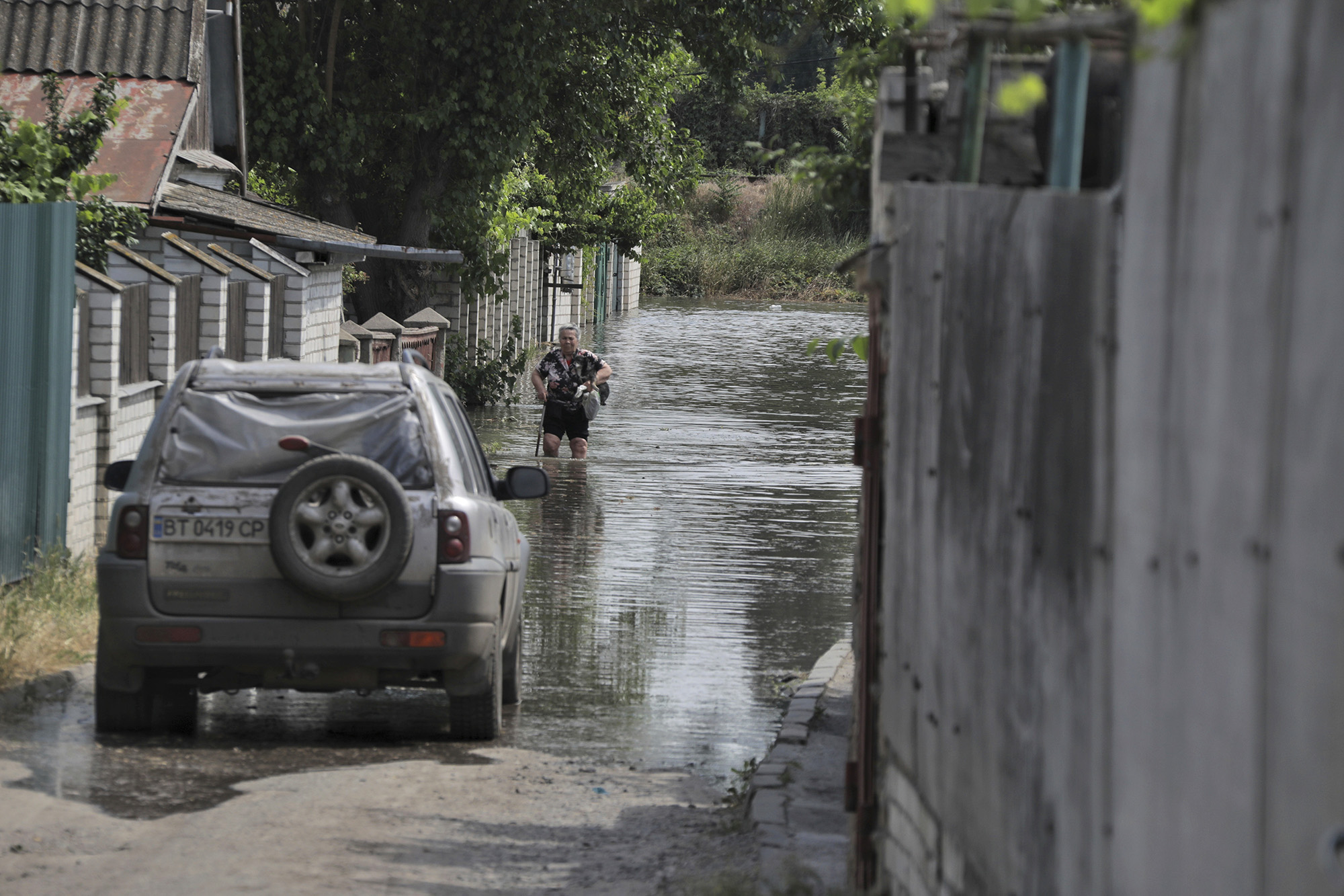 A local resident walks along a flooded street in Kherson, Ukraine, on June 6.