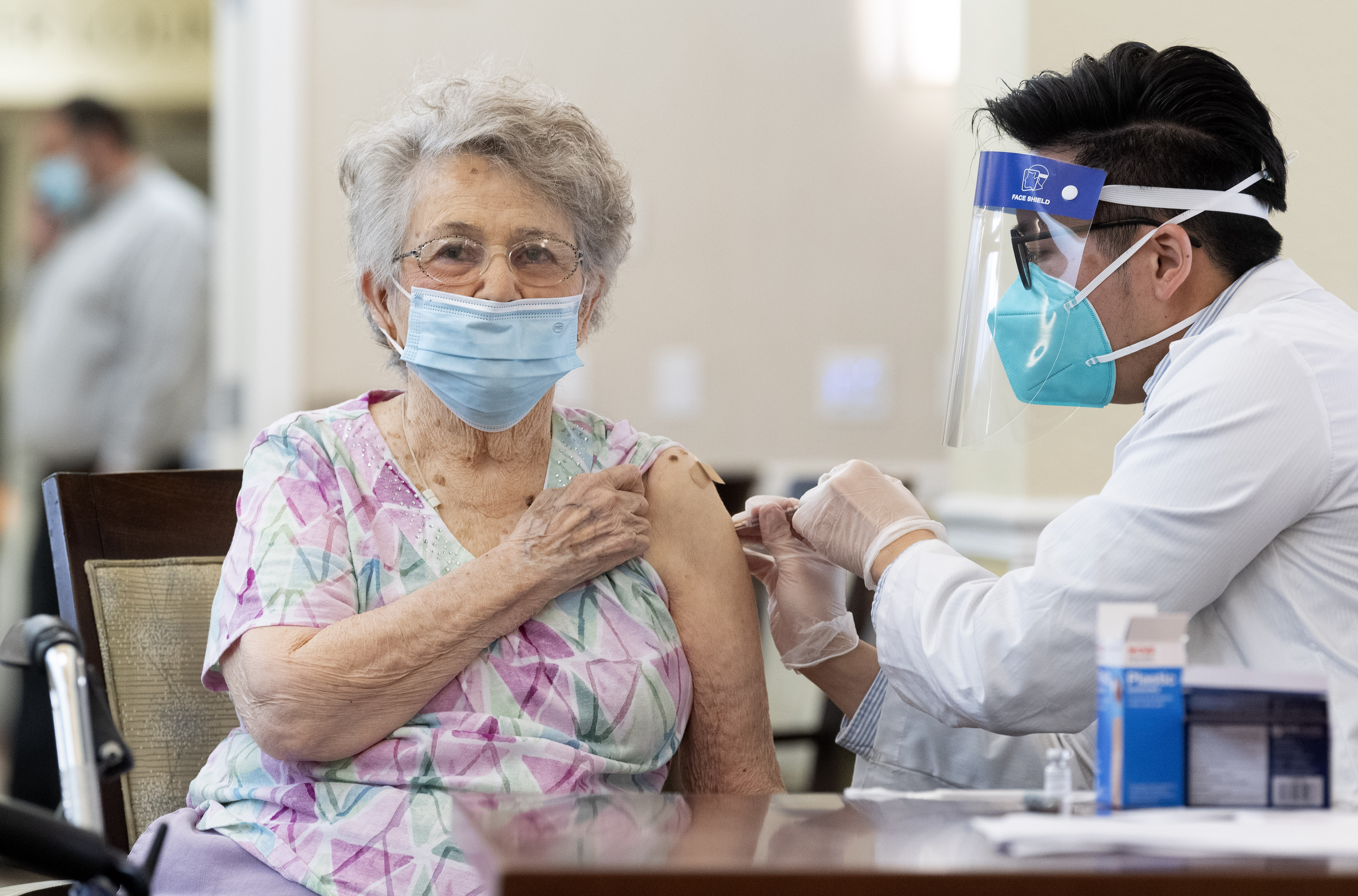 A CVS pharmacist gives the Pfizer/BioNTech COVID-19 vaccine to a resident at the Emerald Court senior living community in Anaheim, CA on Friday, January 8, 2021. The vaccine was optional for staff and residents.