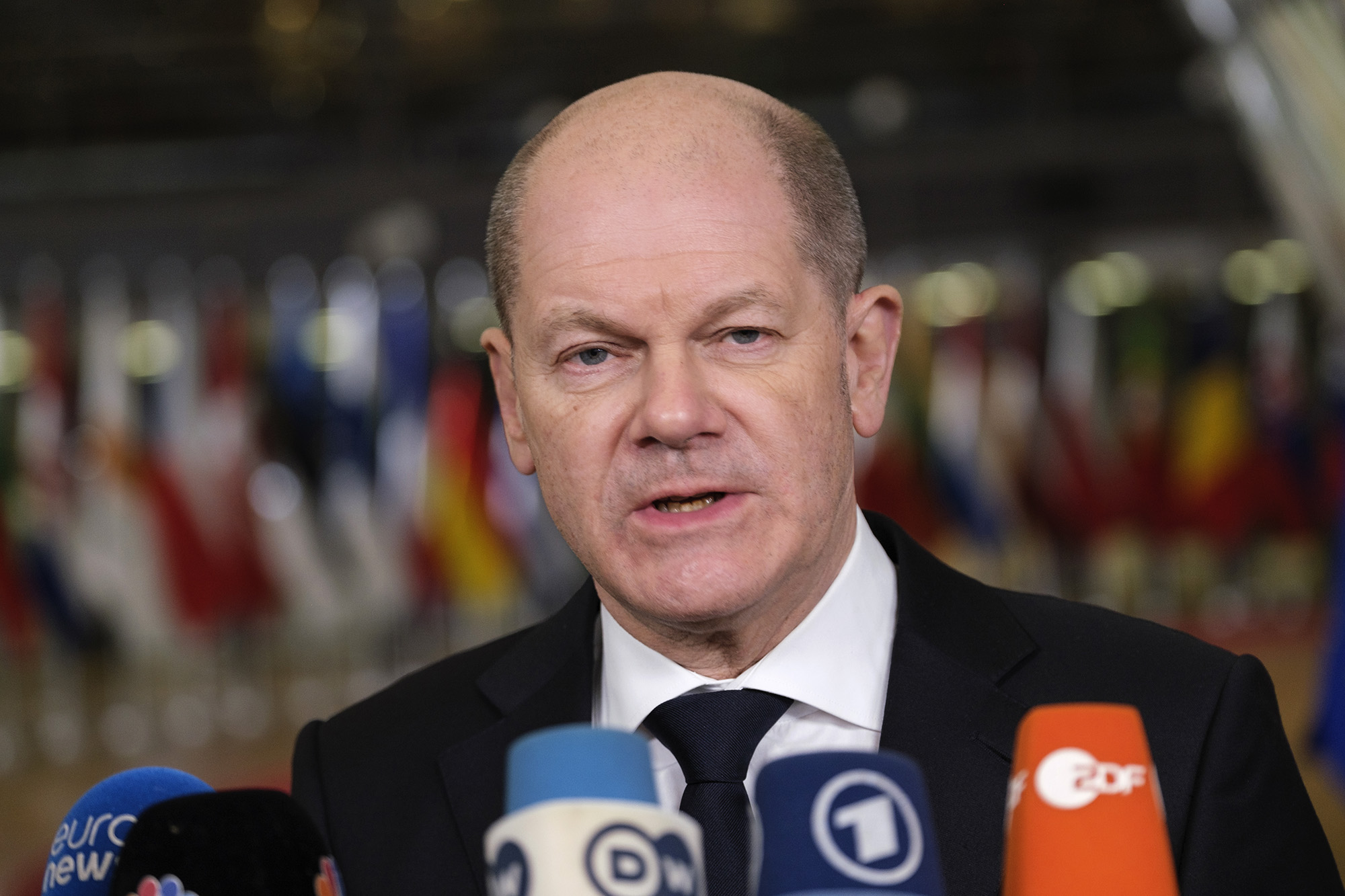 German Chancellor Olaf Scholz talks to the media as he arrives at the EU Council headquarters on February 24, in Brussels, Belgium.