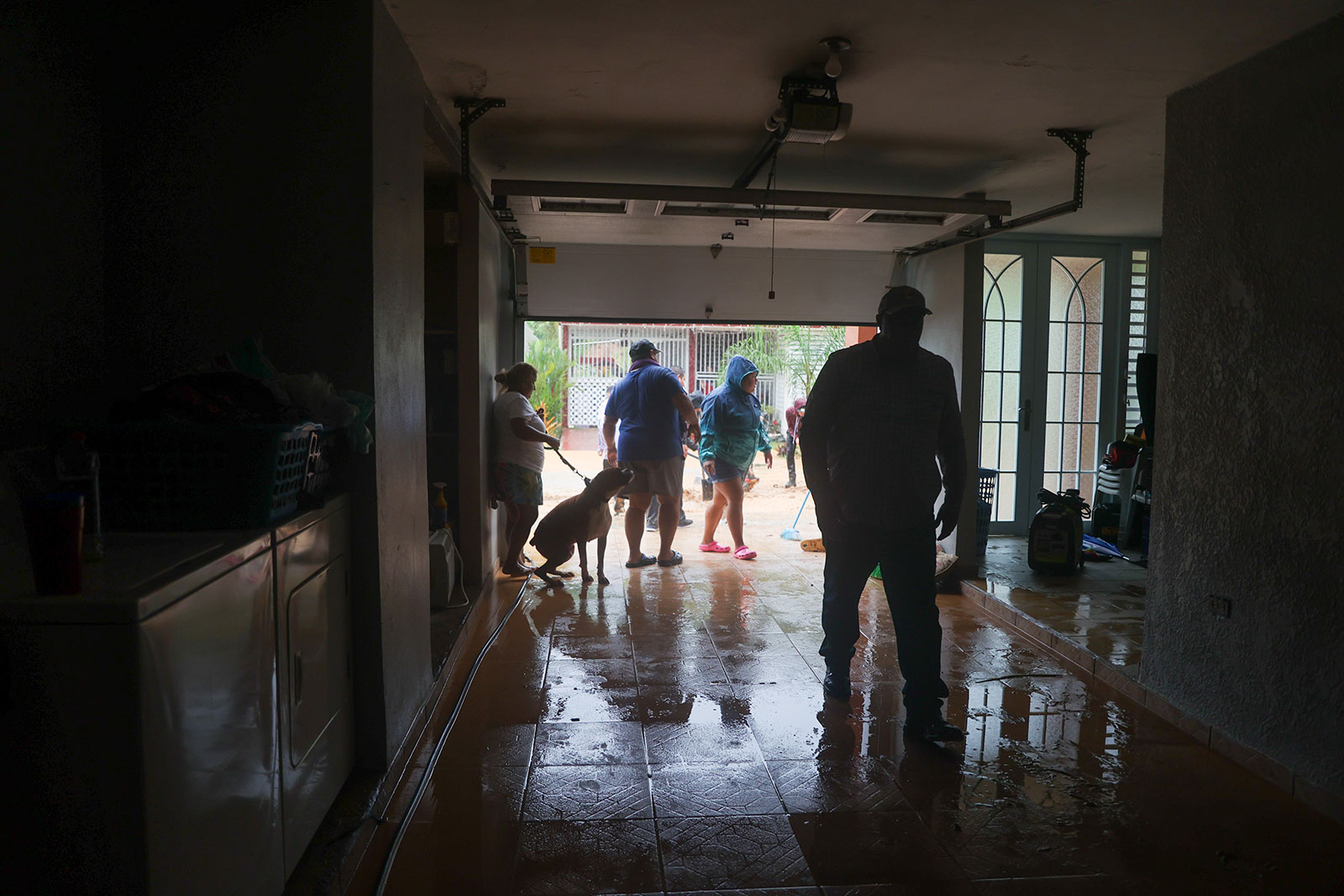 People clean a house flooded by the rains from Hurricane Fiona in Cayey, Puerto Rico on September 18. 
