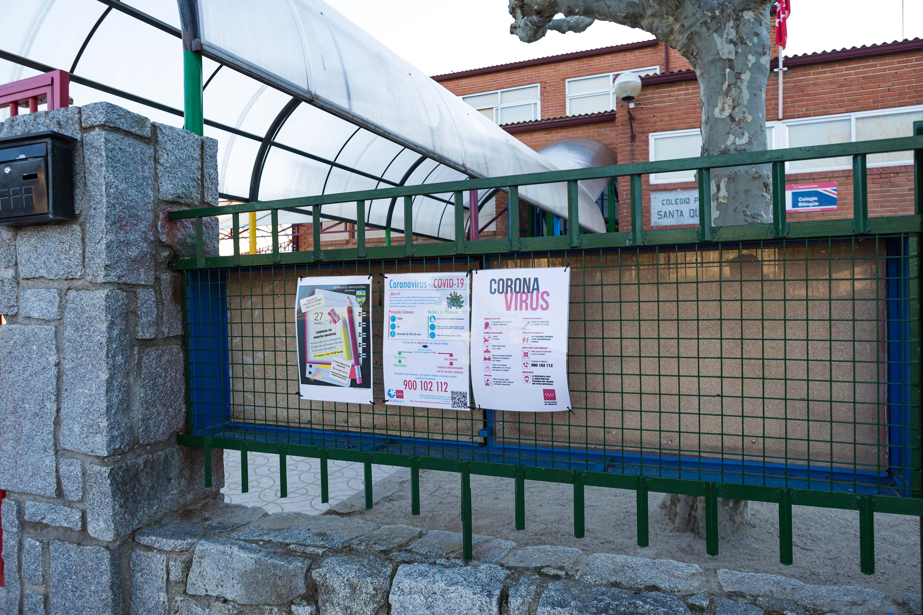 A sign with information about coronavirus is posted at a closed school in Madrid, Spain, on Wednesday.