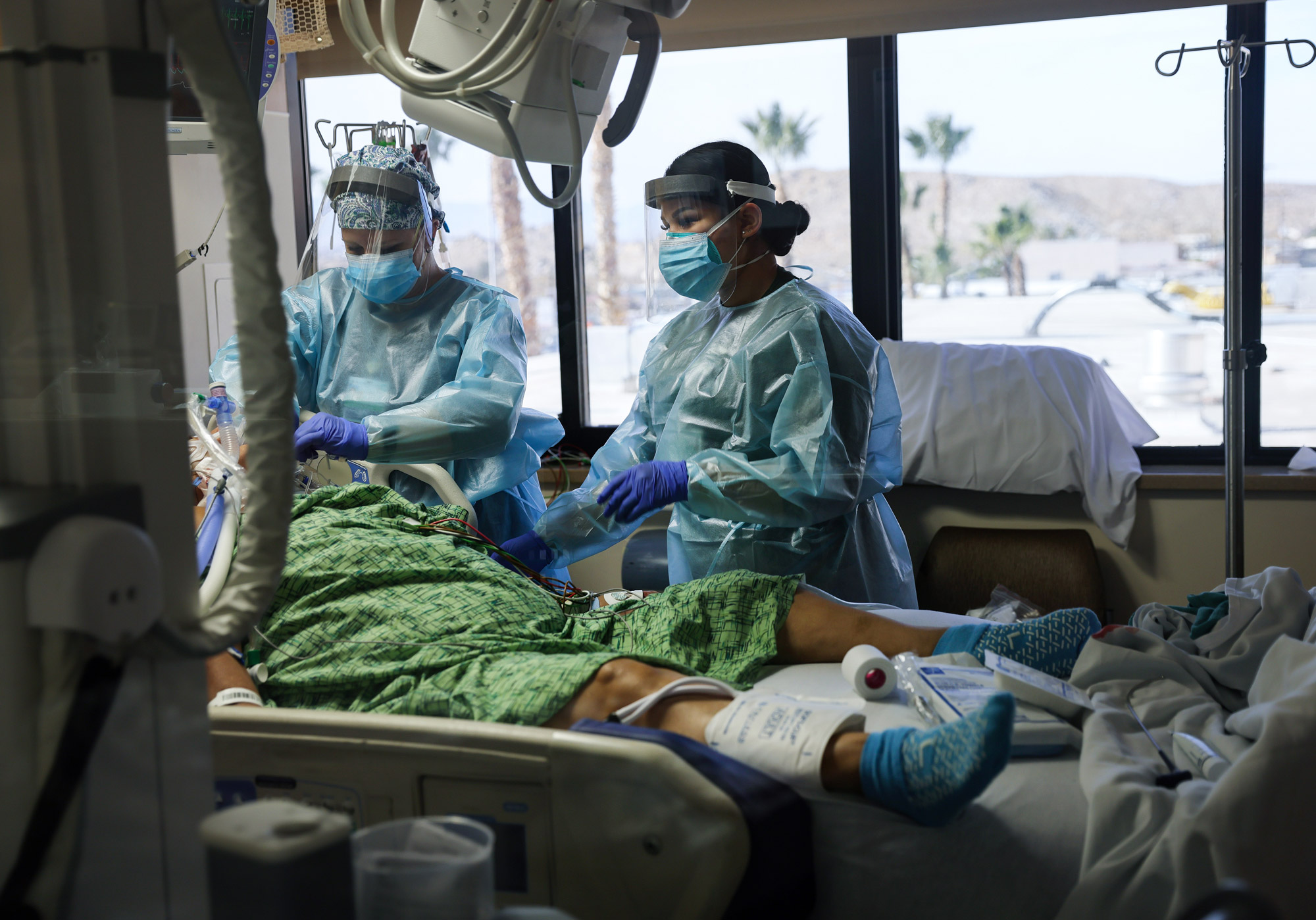 Clinicians care for a COVID-19 patient in the Intensive Care Unit at Providence St. Mary Medical Center on December 23 in Apple Valley, California. 