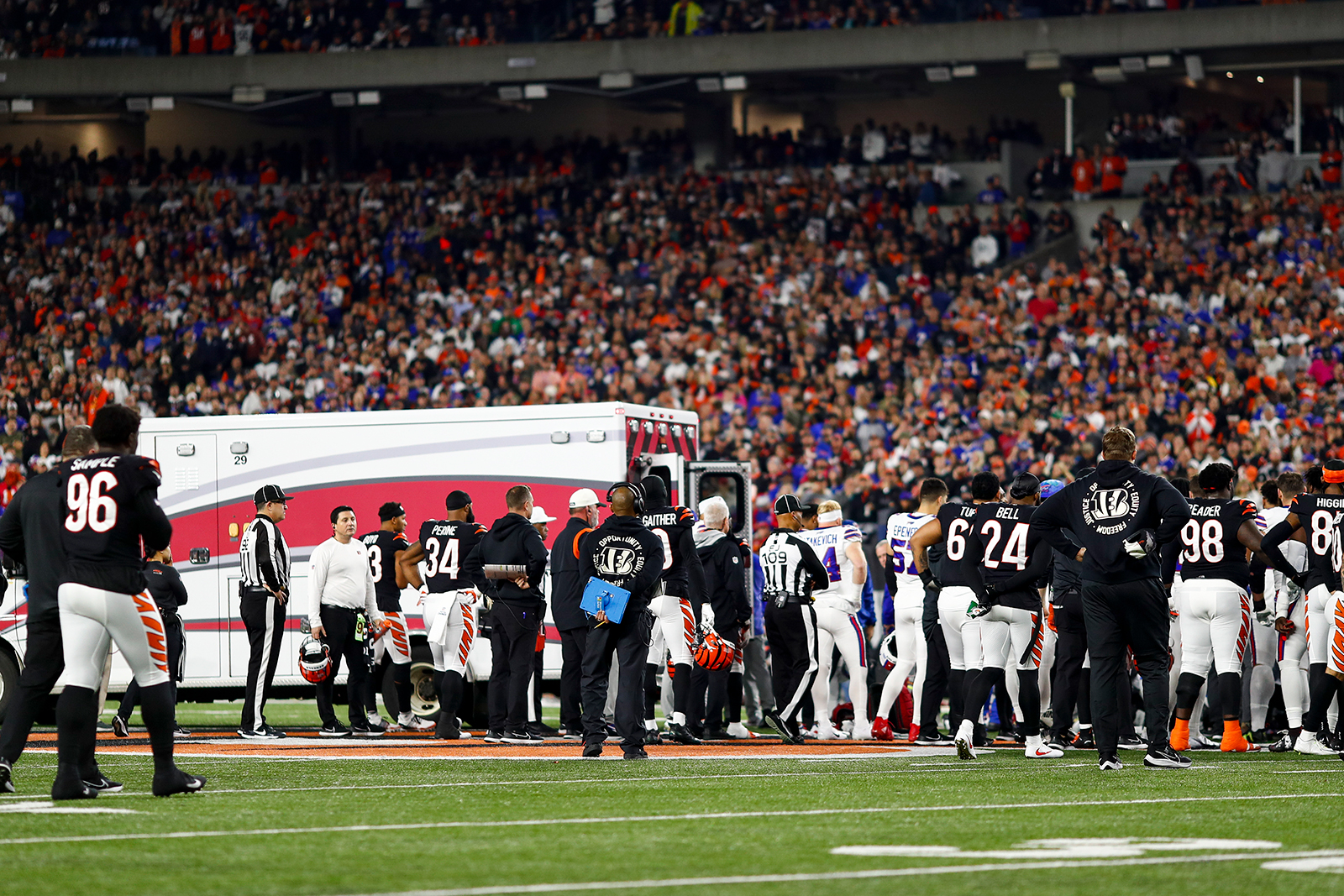 Buffalo Bills and Cincinnati Bengals players react to an injury sustained by safety Damar Hamlin (3) during the first quarter of an NFL game against the Cincinnati Bengals on Monday.