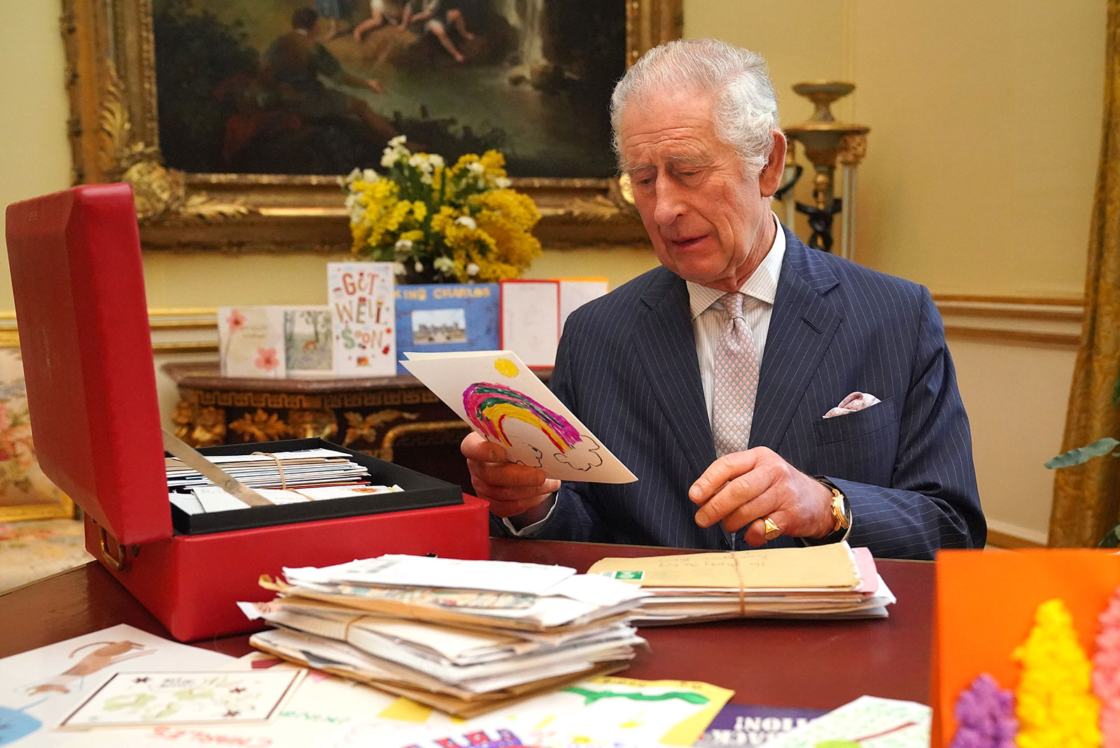King Charles III reads cards and messages, sent by well-wishers following his cancer diagnosis,at Buckingham Palace on February 21,  in London, England. 