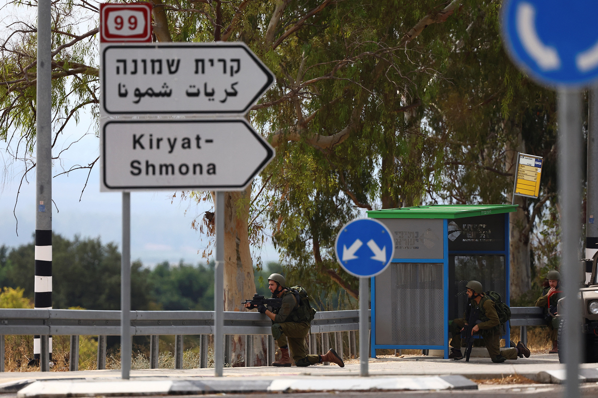 Israeli soldiers kneel in position on patrol in northern Israel on October 10.