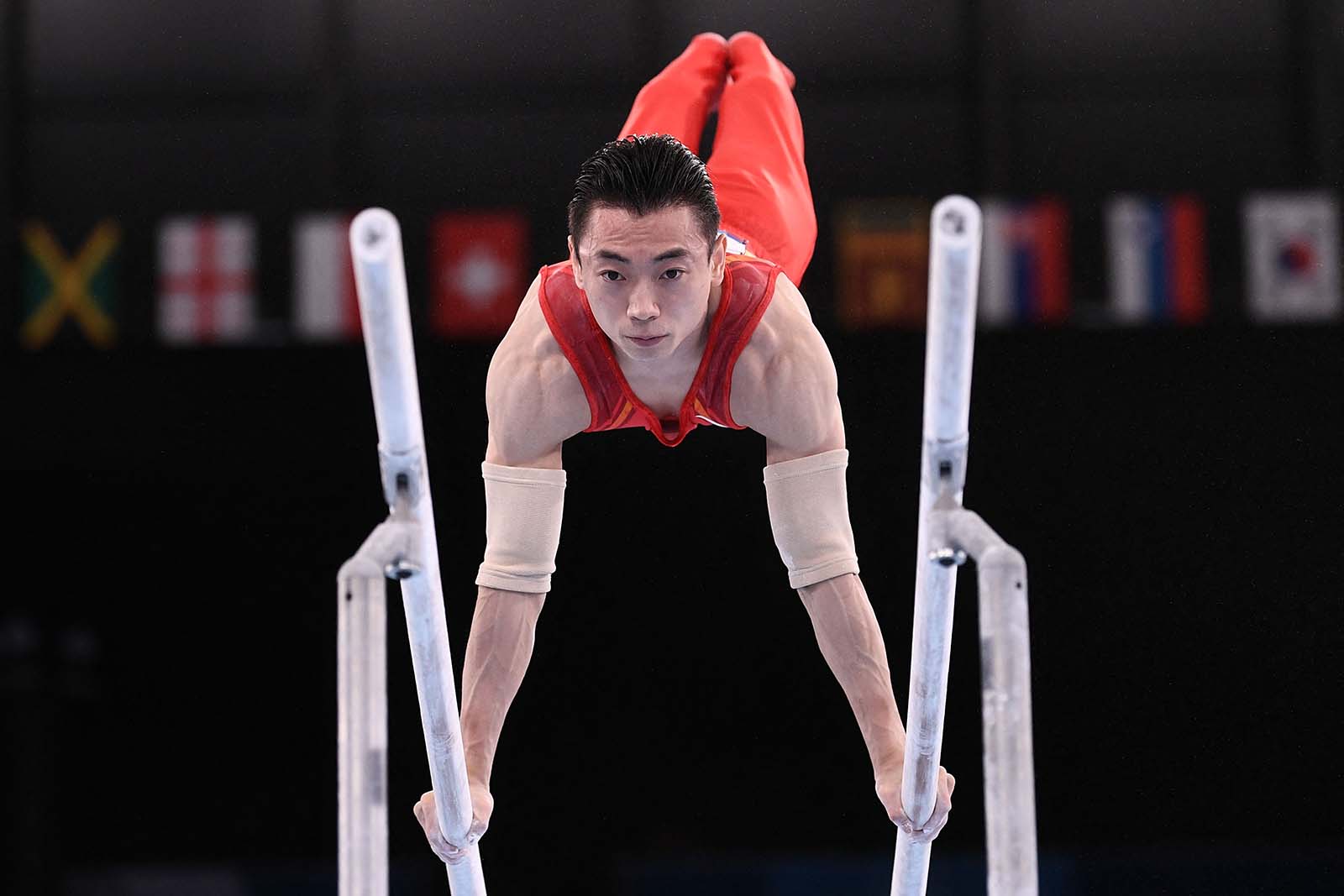 China's Zou Jingyuan competes in the artistic gymnastics men's parallel bars final. 