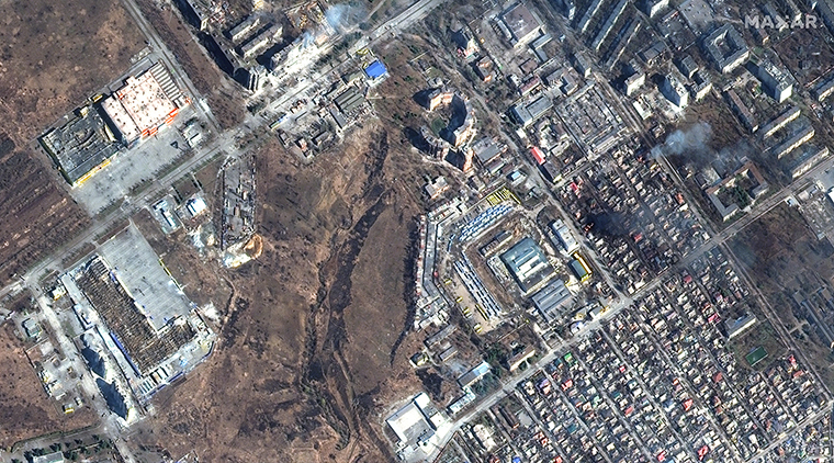 Homes and apartment buildings are seen damaged after an apparent military strike in the the Primorskyi neighborhood.