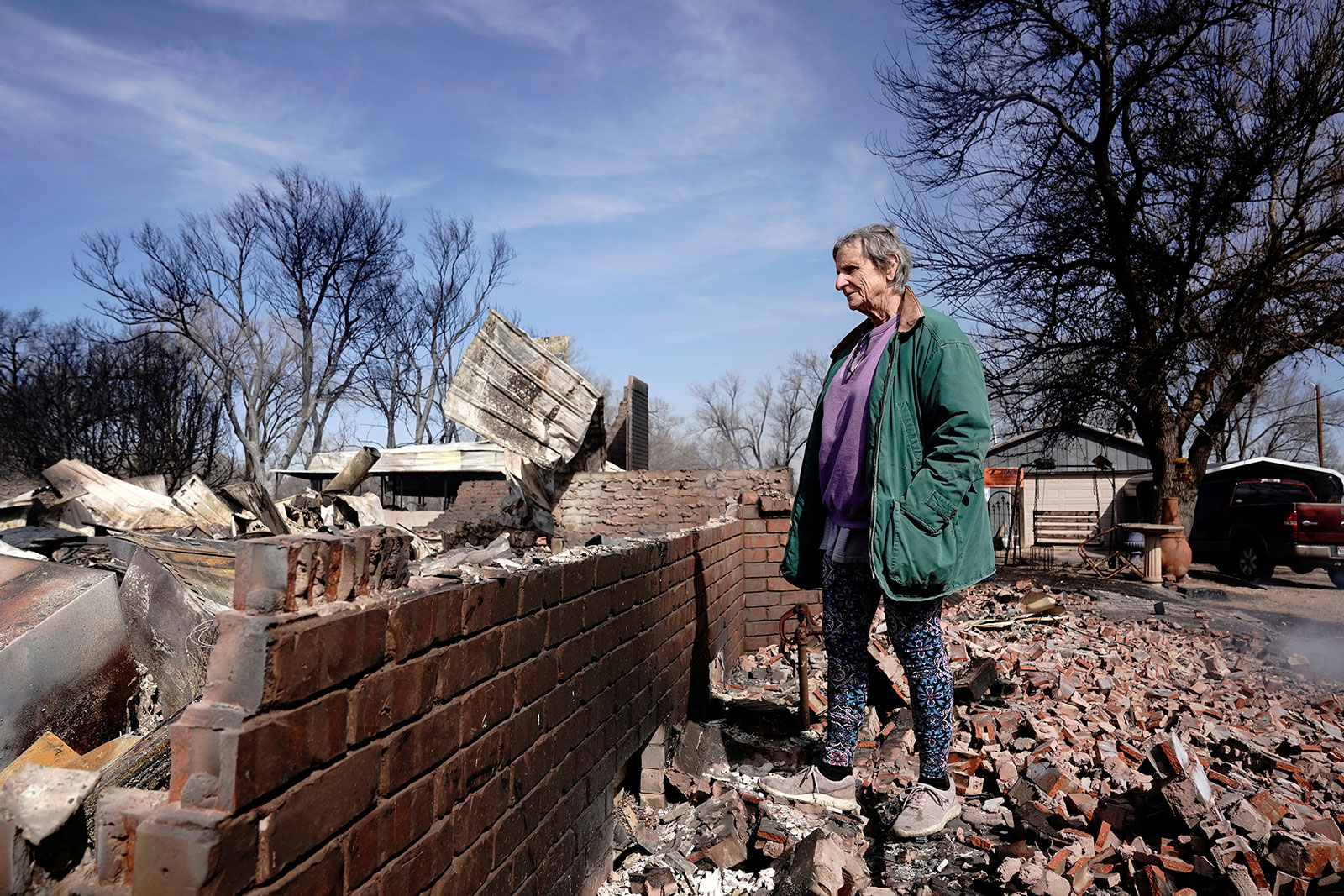 Gilissa Murray looks over her home that was destroyed by the Smokehouse Creek wildfire in Canadian, Texas, on Wednesday.