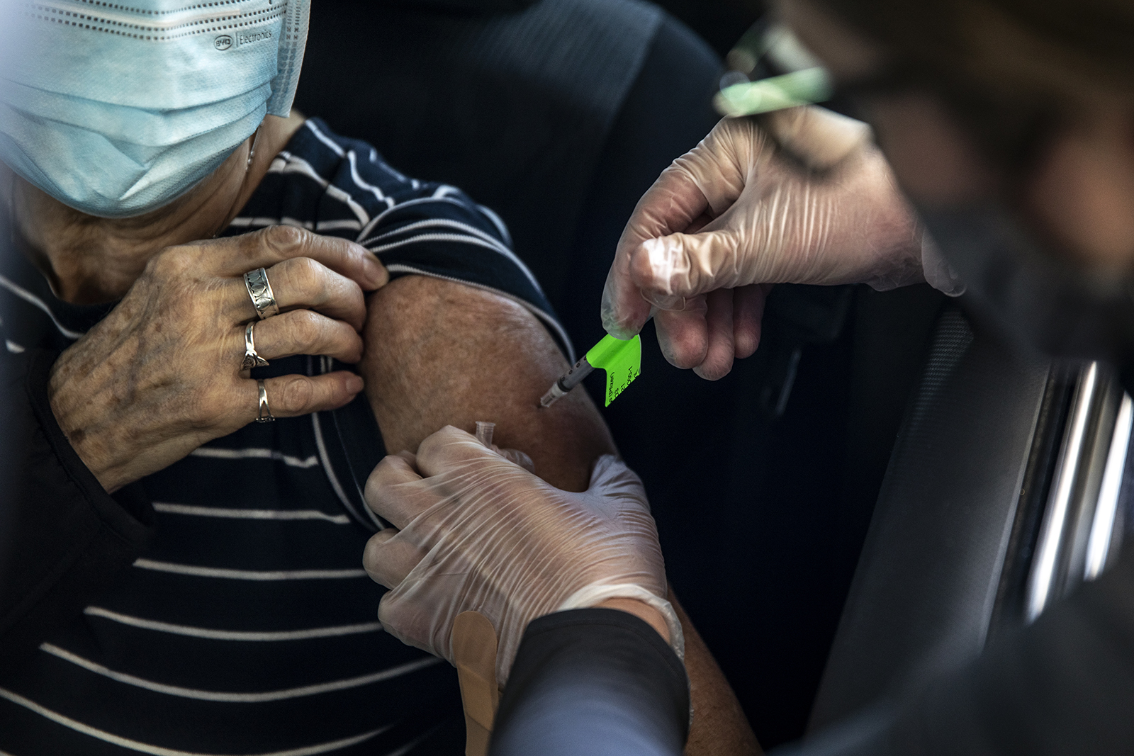 A health care worker administers a dose of the Pfizer-BioNTech Covid-19 vaccine at Coors Field in Denver, Colorado, on February 20.