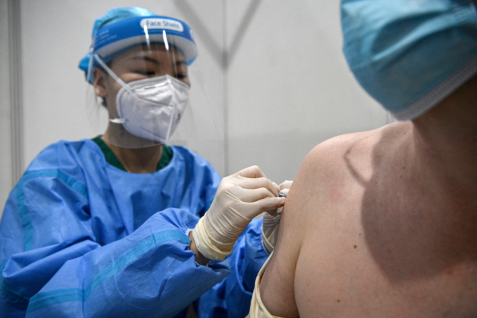 A medical worker administers the Sinopharm Covid-19 vaccine on an individual in Beijing, on April 15.