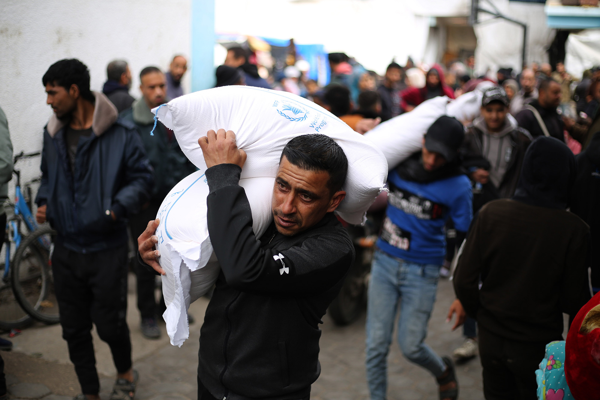 A man carries relief supplies provided by the United Nations Relief and Works Agency for Palestine Refugees, UNRWA, in the southern Gaza city of Rafah, on January 28.
