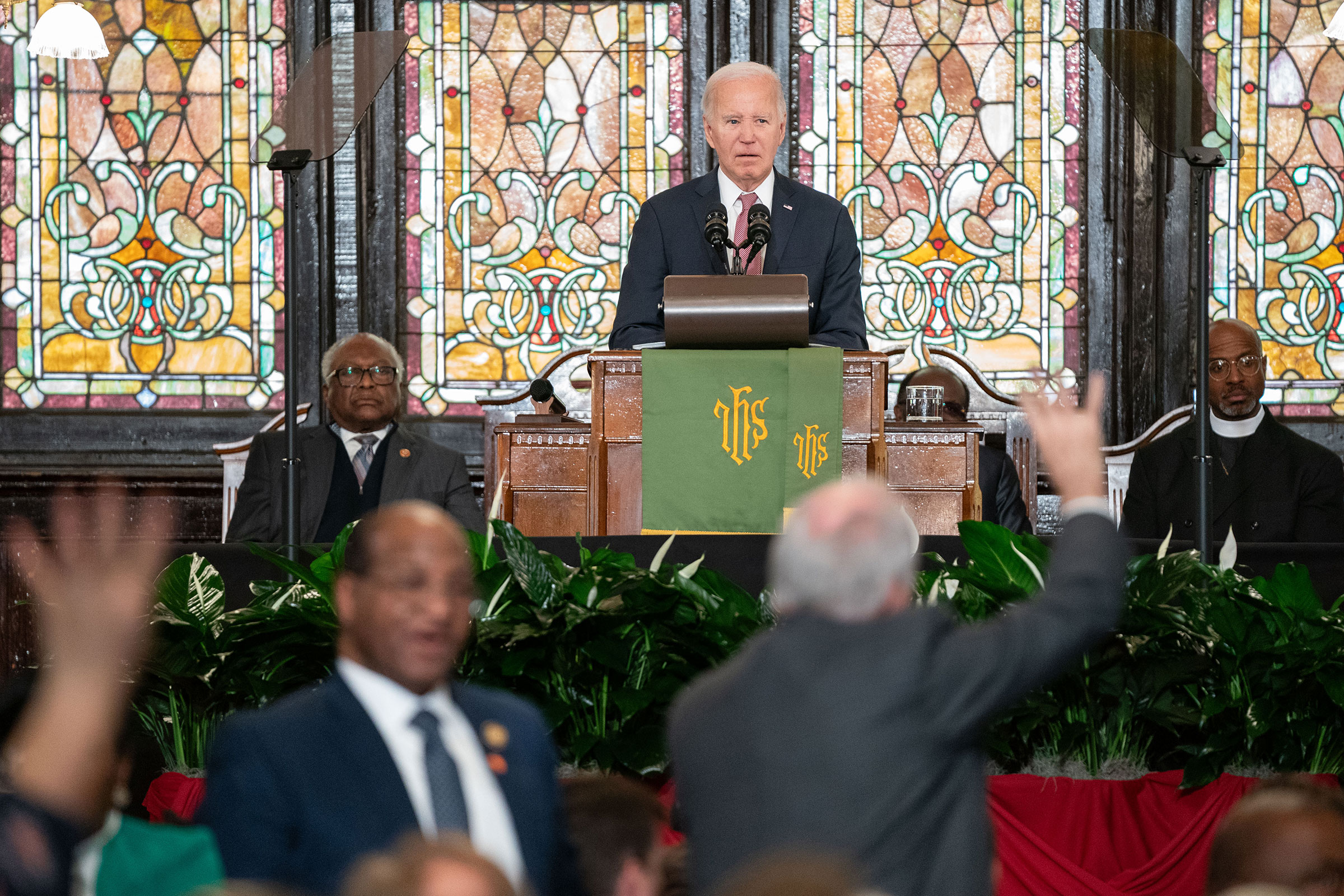 President Joe Biden watches as protestors are escorted out of the building during a campaign event at Emanuel AME Church on January 8, in Charleston, South Carolina. 