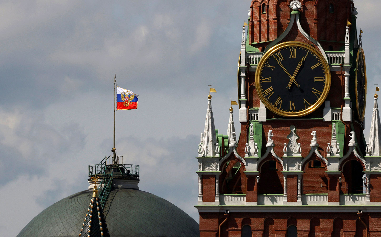 The Russian flag flies on the dome of the Kremlin Senate building, where the roof shows what appears to be damage from the recent drone incident, in Moscow, Russia, on May 4.