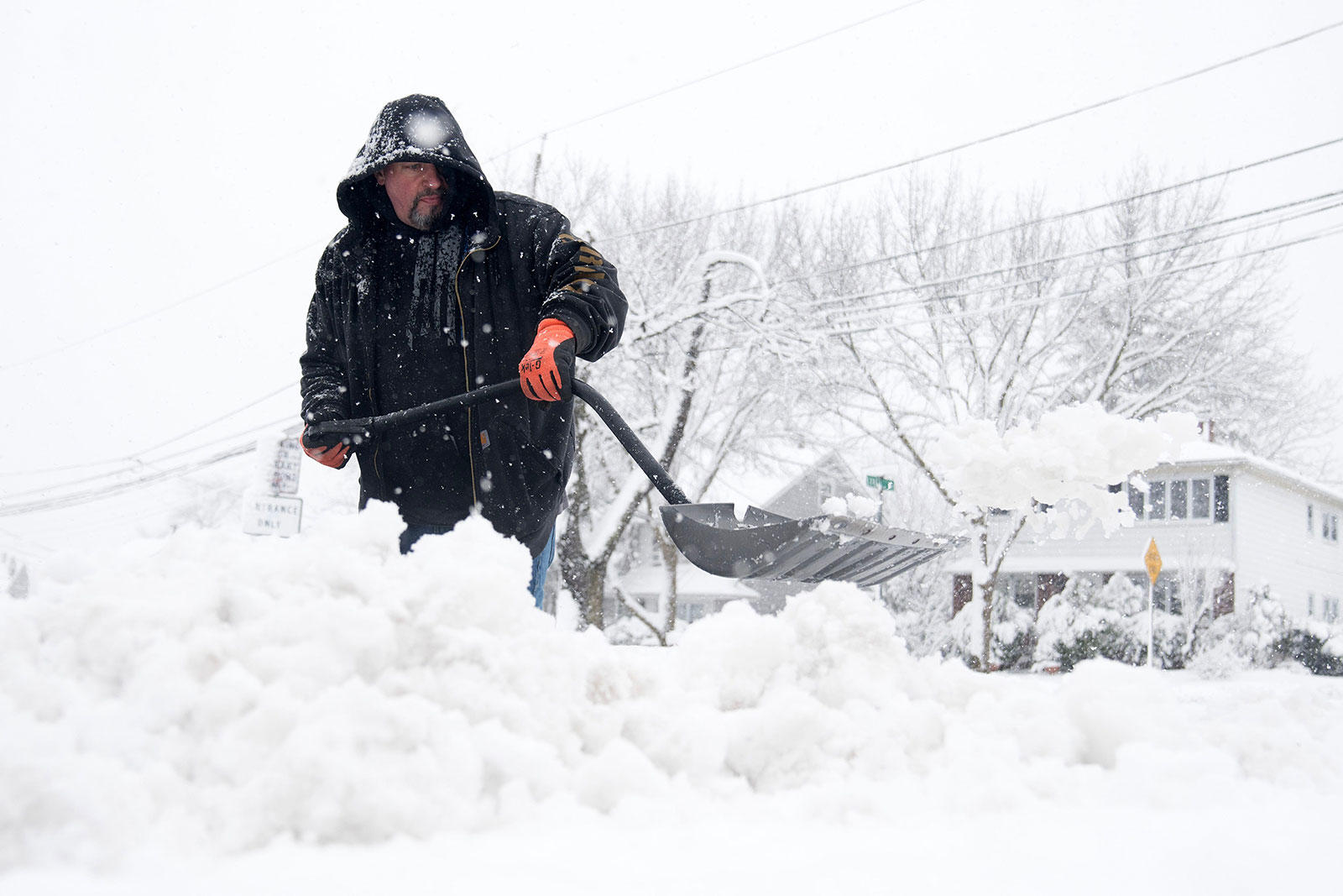 Darren Krukiel shovels snow in Clifton, New Jersey, on Tuesday.