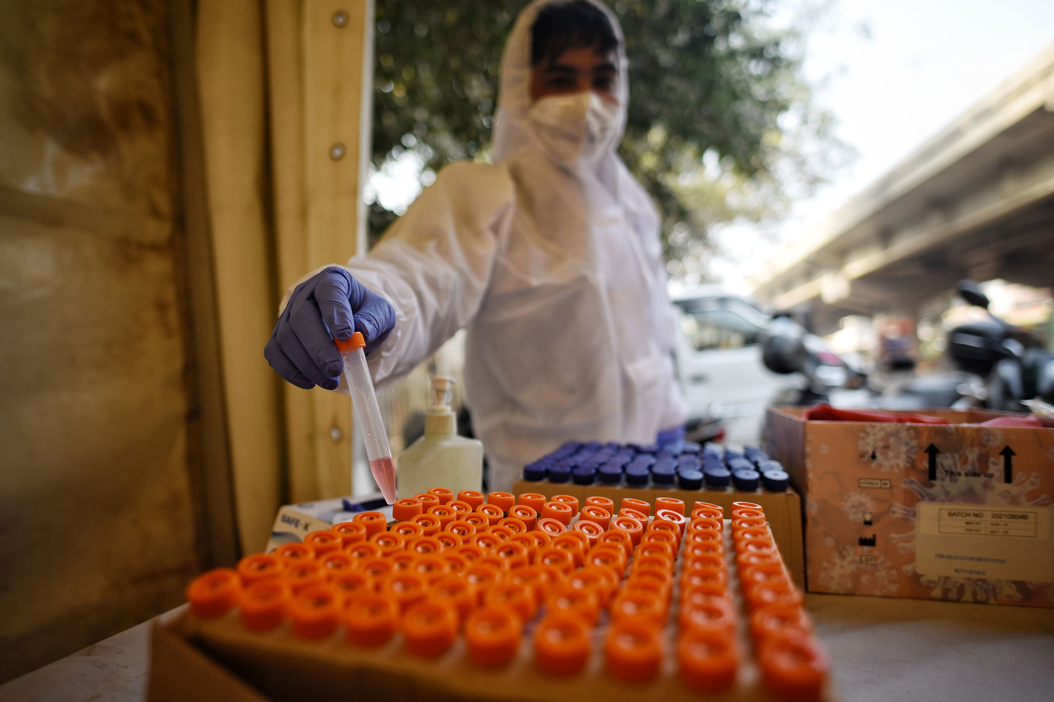 A health worker collects samples for Covid-19 testing at Shahdara, New Delhi, India, on December 18, 2021