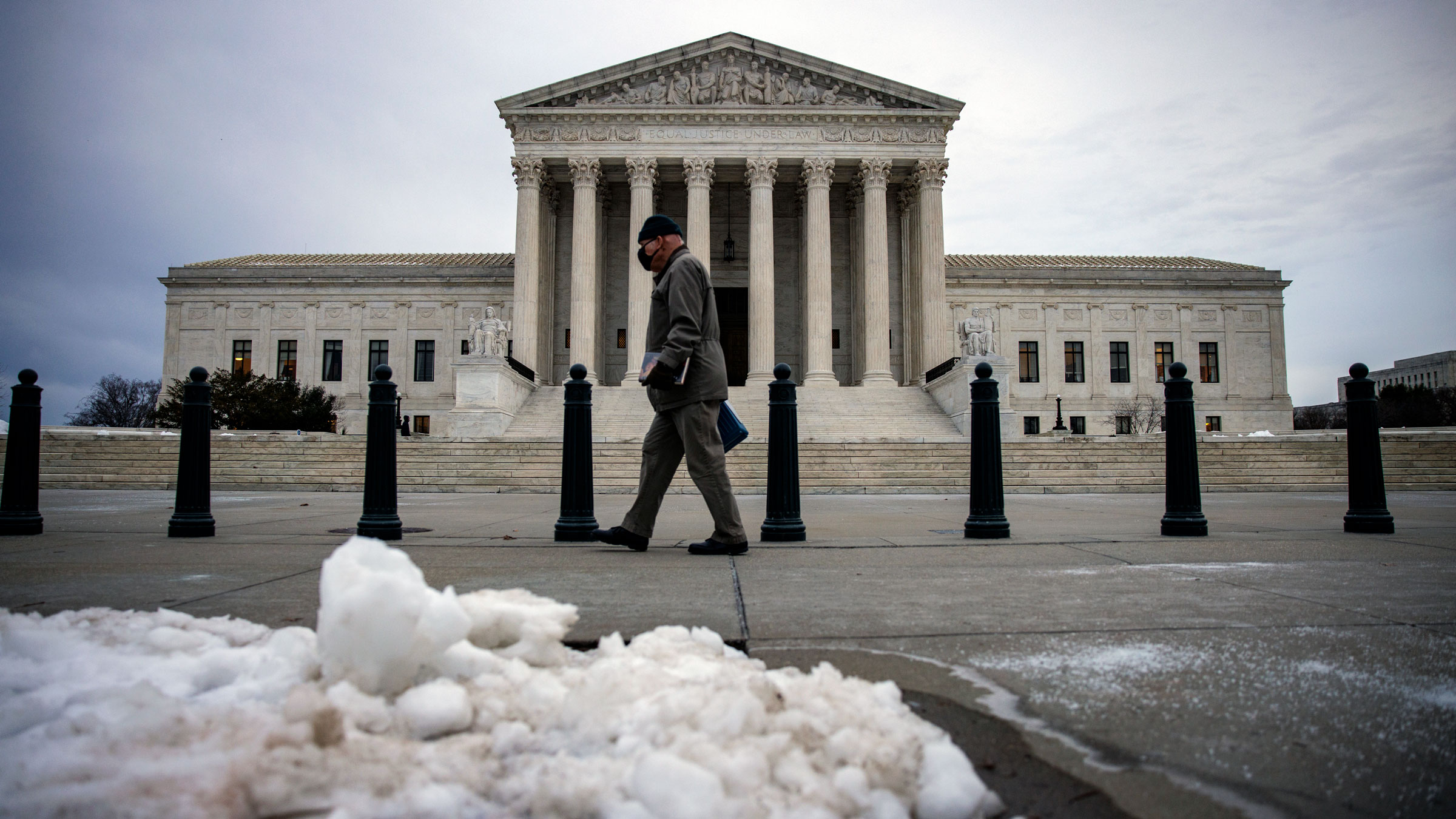 A man walks past the US Supreme Court on Friday morning.