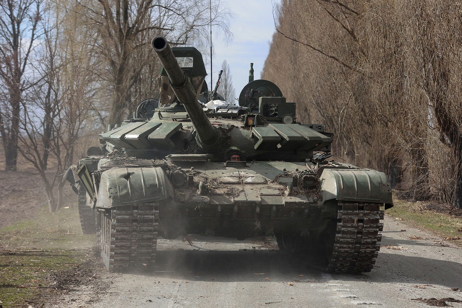 A Ukrainian service member drives a captured Russian T-72 tank in Lukianivka, Ukraine, in March 2022. 