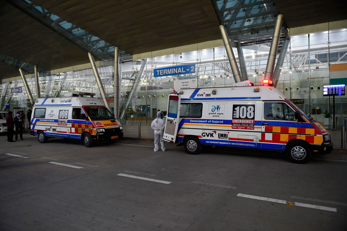 A health worker stands beside ambulances parked outside the Sardar Vallabhbhai Patel International Airport, in Ahmedabad, India, upon the arrival of passengers from the UK on December 22.