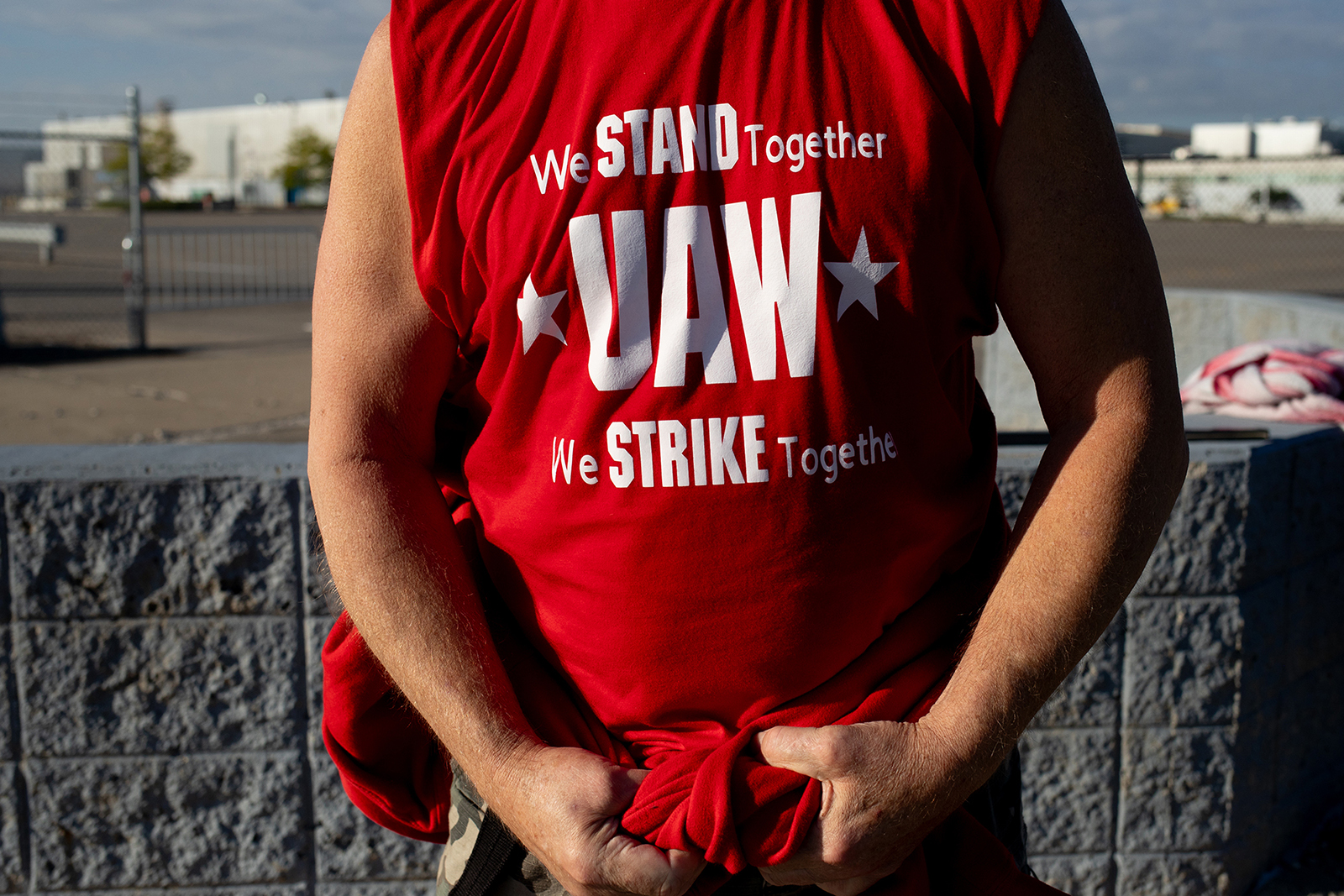 A United Auto Workers member wears a shirt supporting the strike on a picket line outside the Ford Motor Co. Michigan assembly plant in Wayne, Michigan, today.