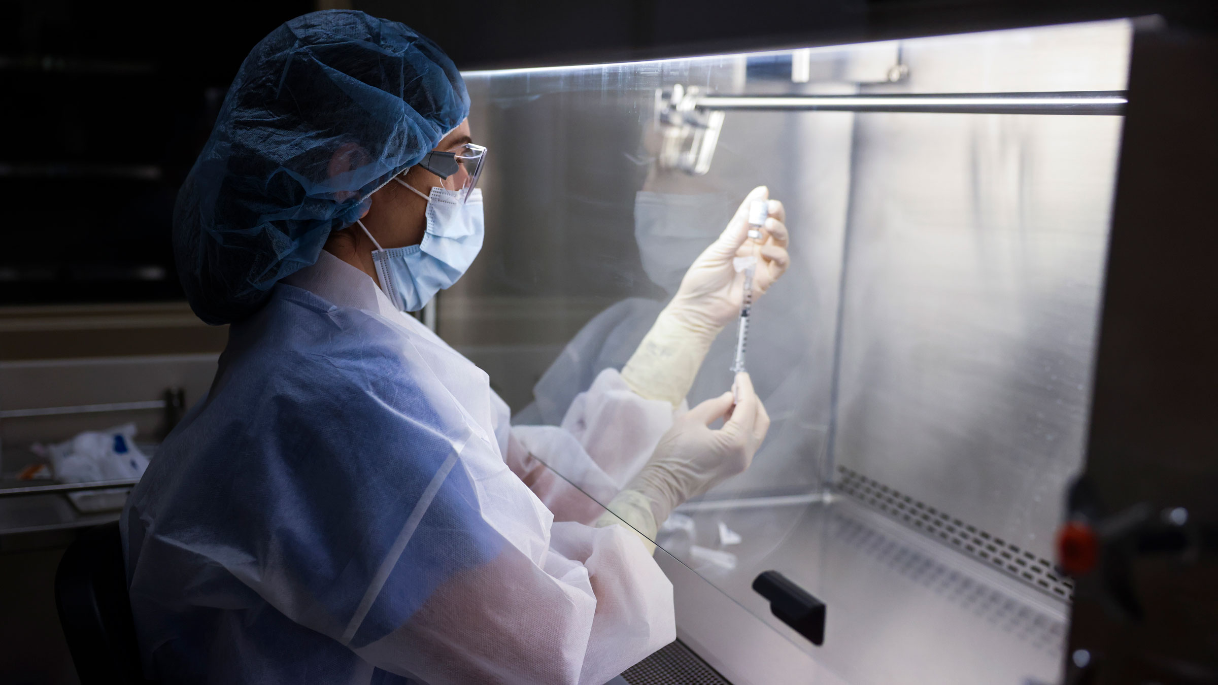 Pharmacy technician Sara Berech prepares a dose of the Johnson & Johnson vaccine for a clinical trial in Aurora, Colorado, in December.