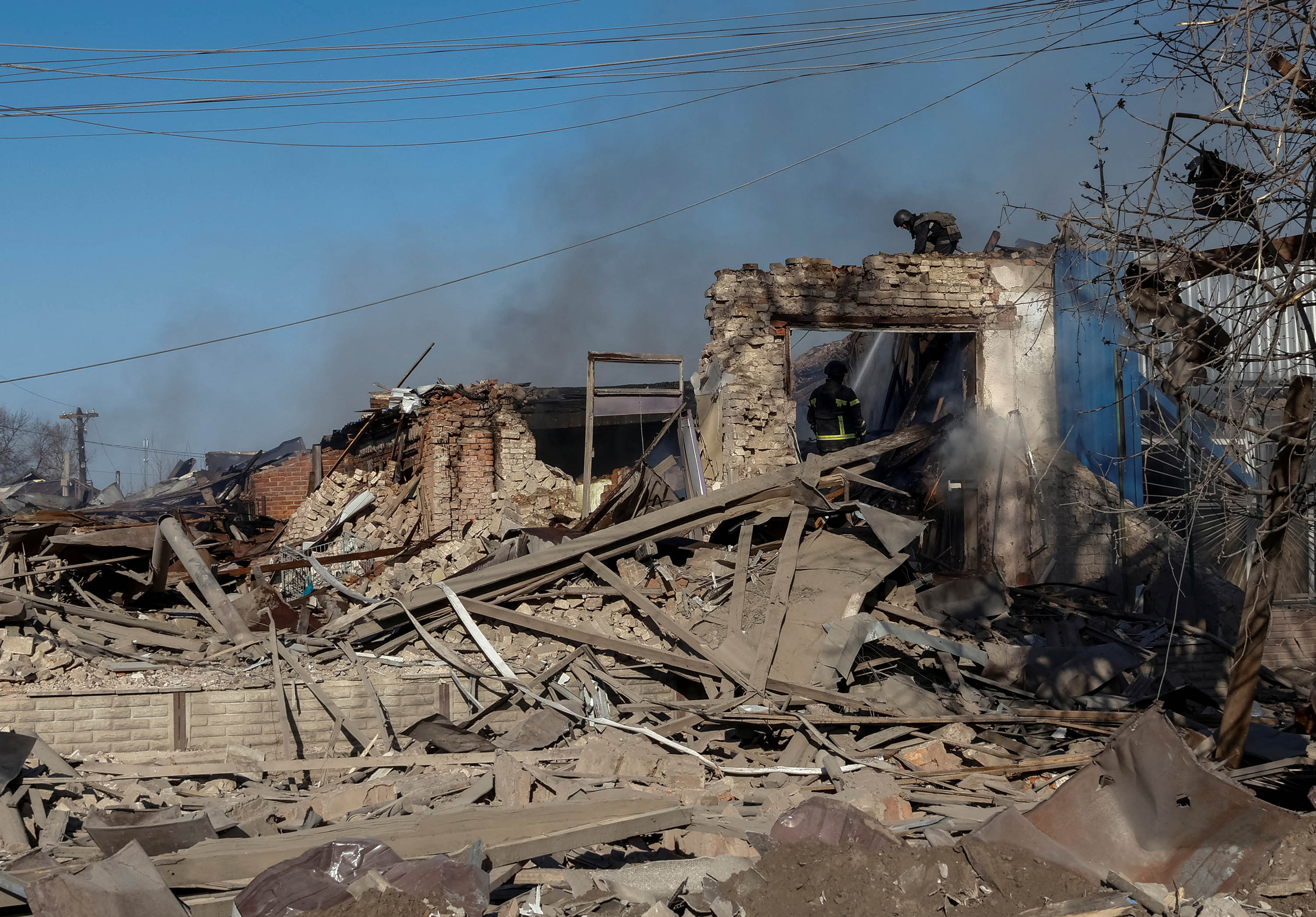 Rescuers work at the site of Russian air strikes in the village of Lyptsi, Ukraine, on April 10. 