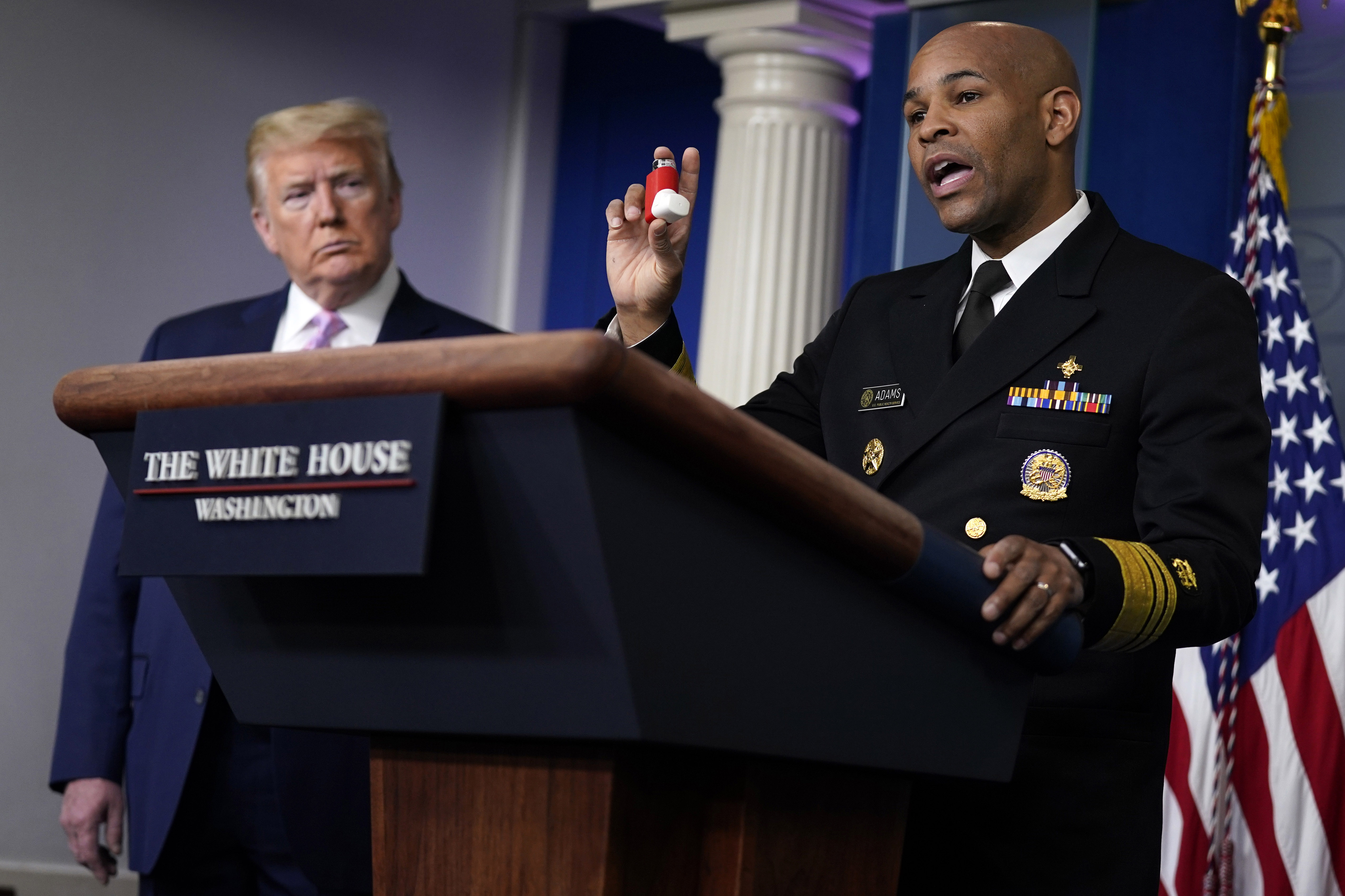 US Surgeon General Dr. Jerome Adams shows his asthma inhaler during a coronavirus task force briefing at the White House on April 10.