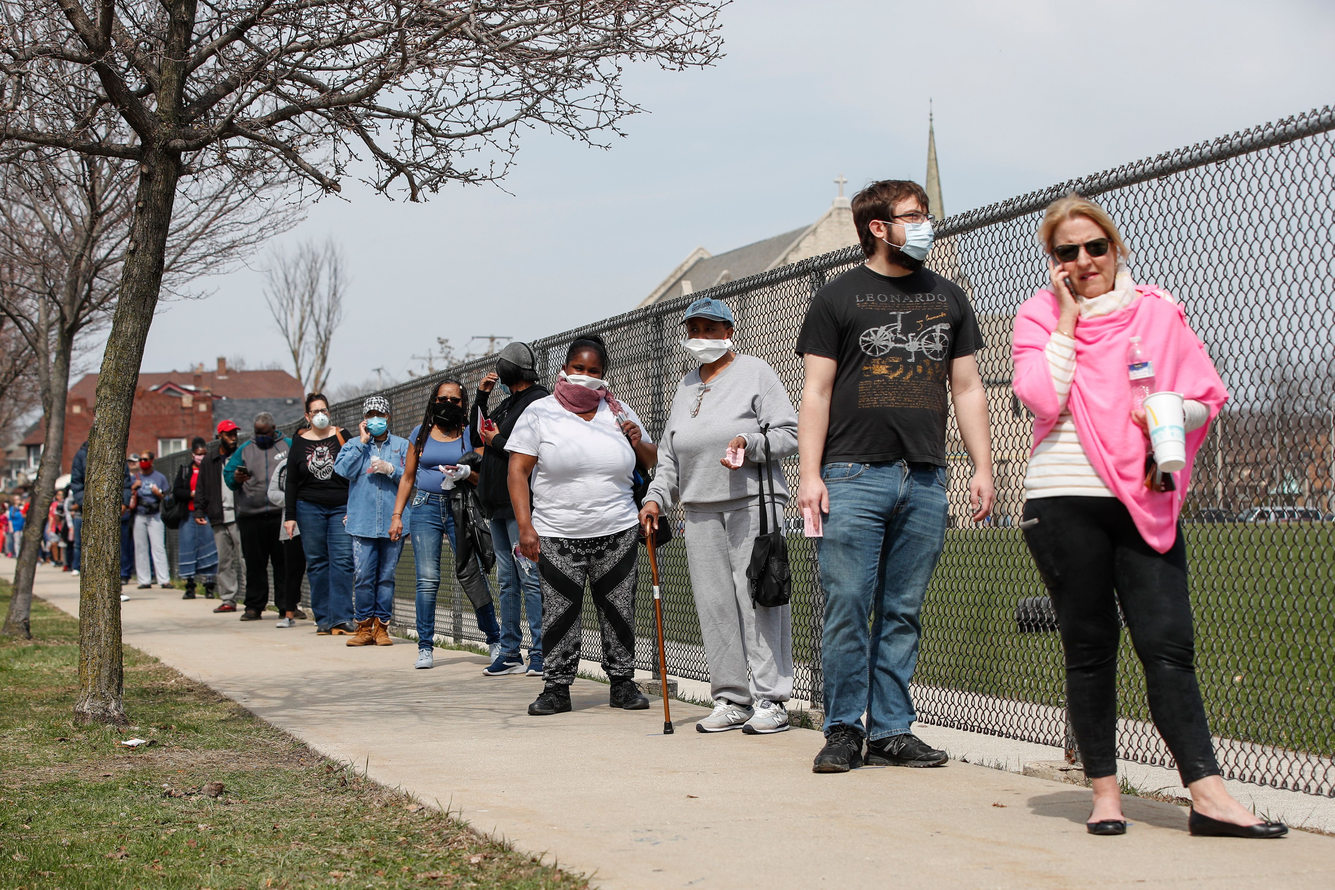 People wait in line to vote in Wisconsin's presidential primary election at Riverside High School in Milwaukee on April 7.