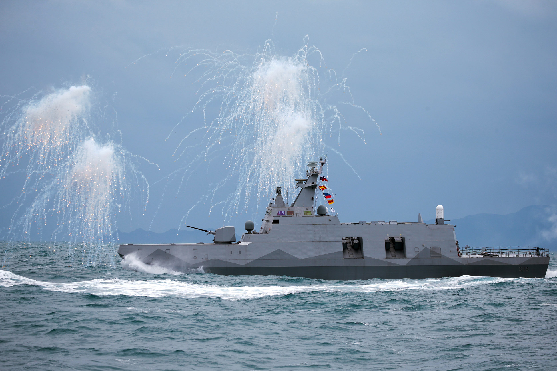 A Taiwan Navy Tuo Chiang-class corvette shoots decoy flares during a military exercise off the shore in Keelung, Taiwan, on Jan. 7.